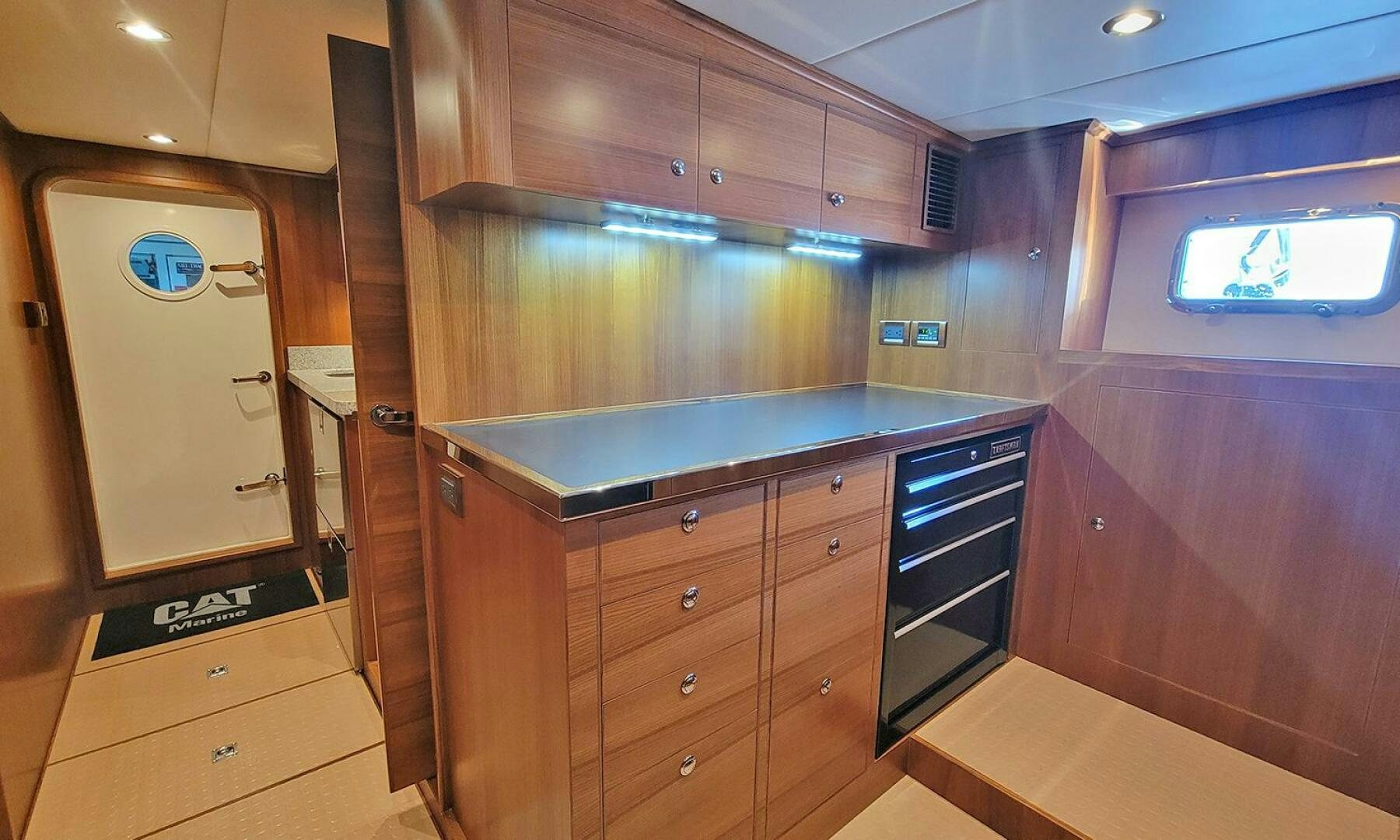 a kitchen with wooden cabinets aboard OKIE Yacht for Sale