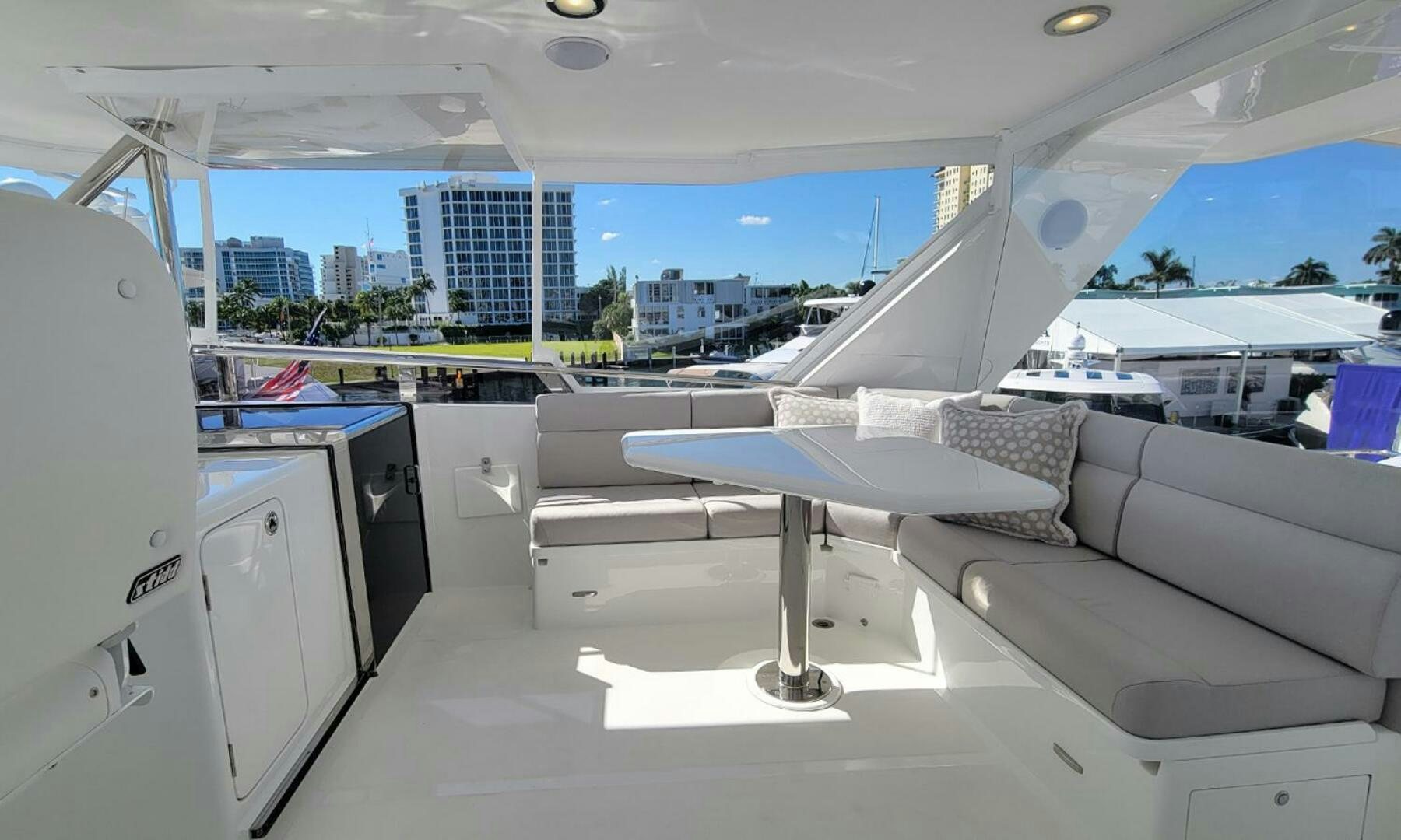 a room with a couch and a table and a large window aboard OKIE Yacht for Sale