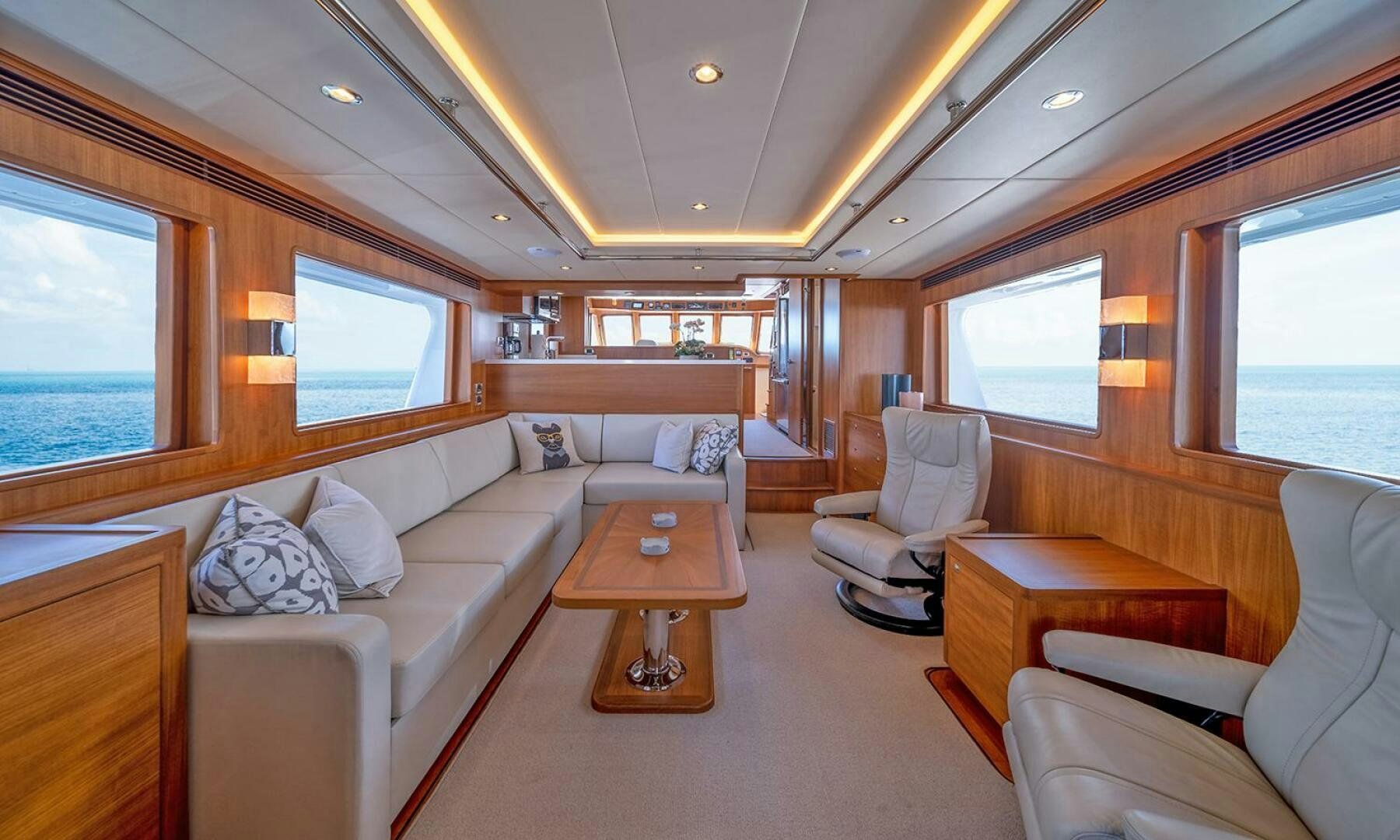 a train car with a couch and a coffee table aboard OKIE Yacht for Sale