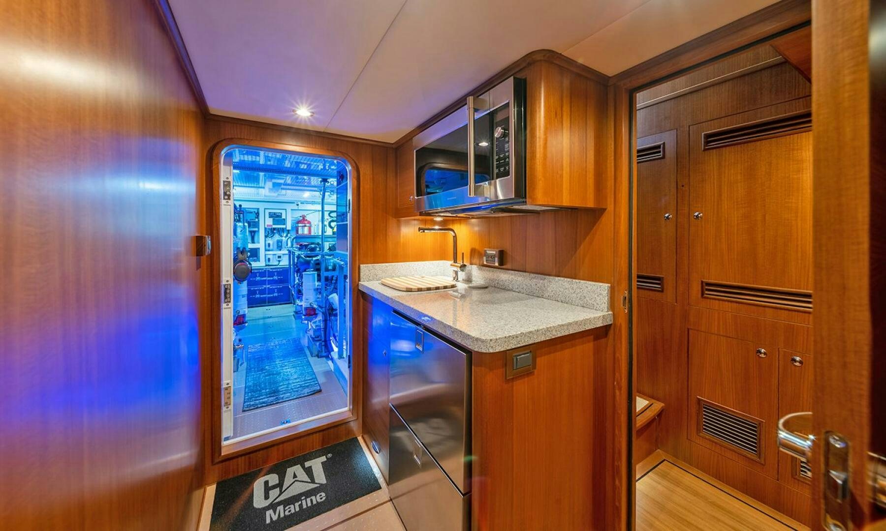 a kitchen with wooden cabinets aboard OKIE Yacht for Sale