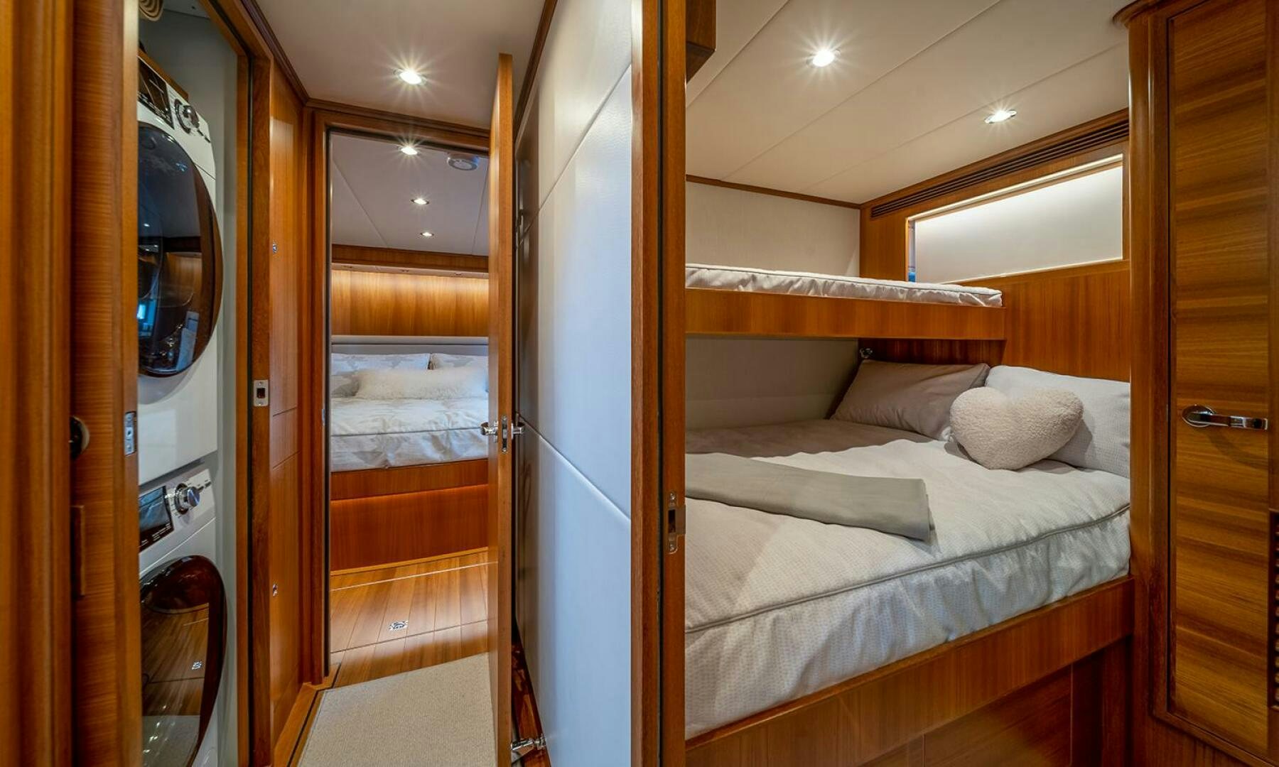a bedroom with a bed and a mirror aboard OKIE Yacht for Sale