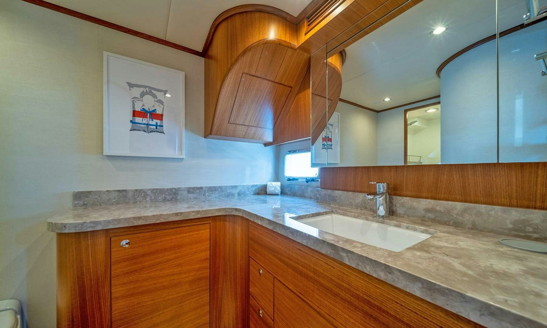 a bathroom with a countertop sink and cabinets aboard OKIE Yacht for Sale