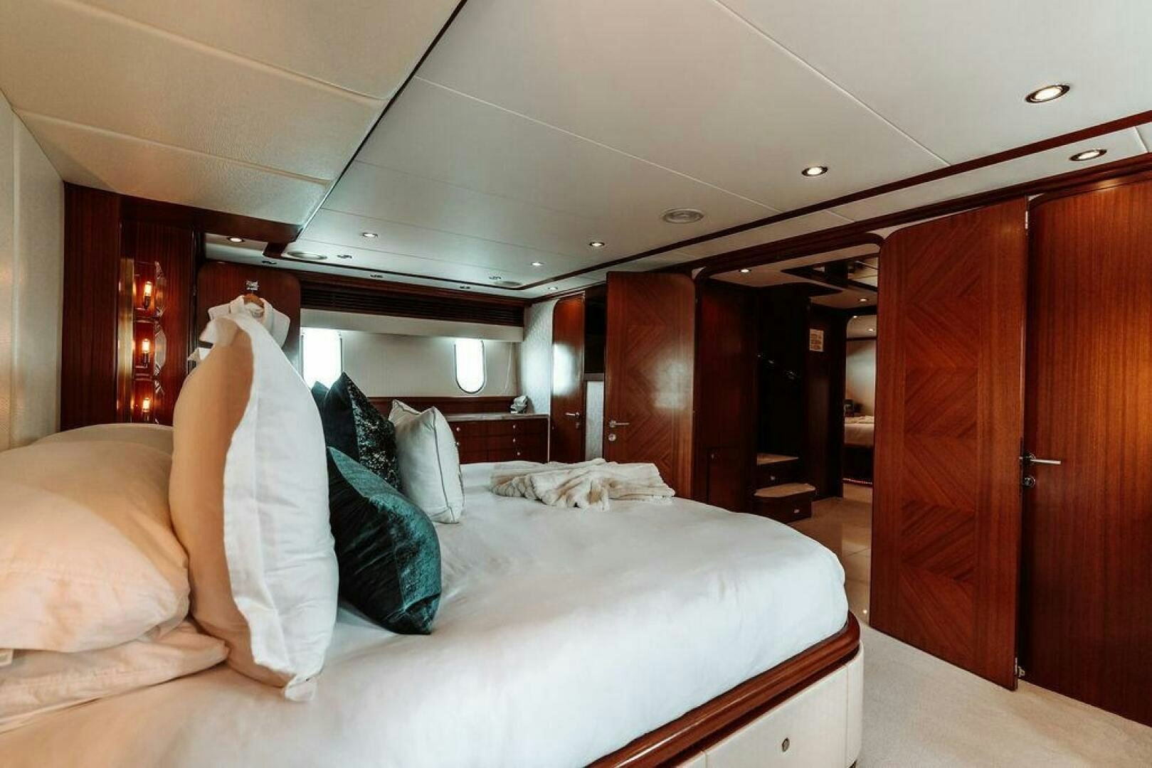 a room with a bed and a closet aboard BEACHFRONT Yacht for Sale