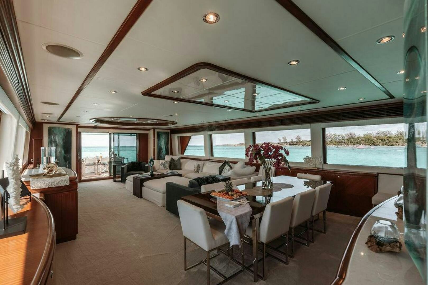 a living room with a large table and chairs aboard BEACHFRONT Yacht for Sale