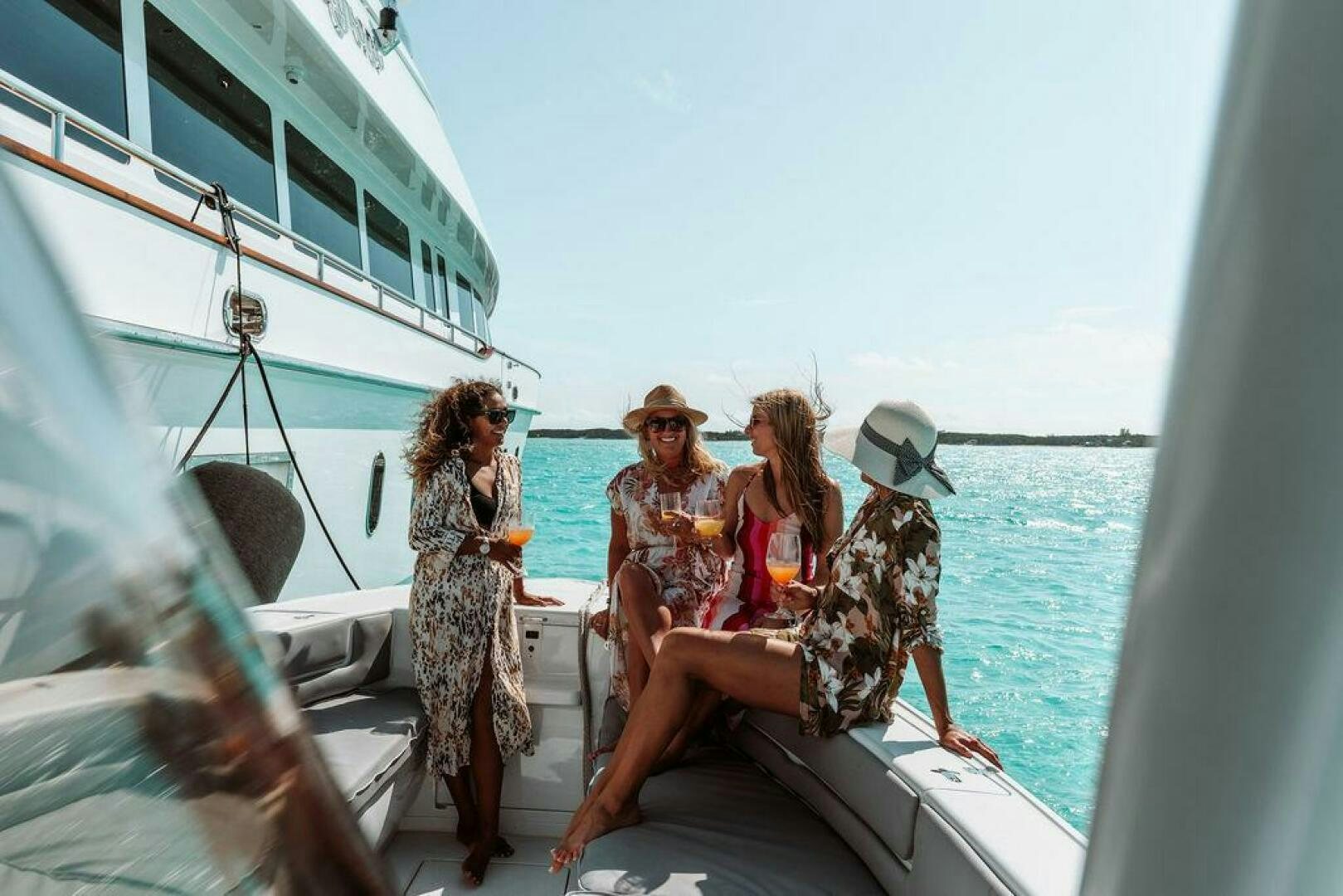 a group of people sitting on a boat aboard BEACHFRONT Yacht for Sale