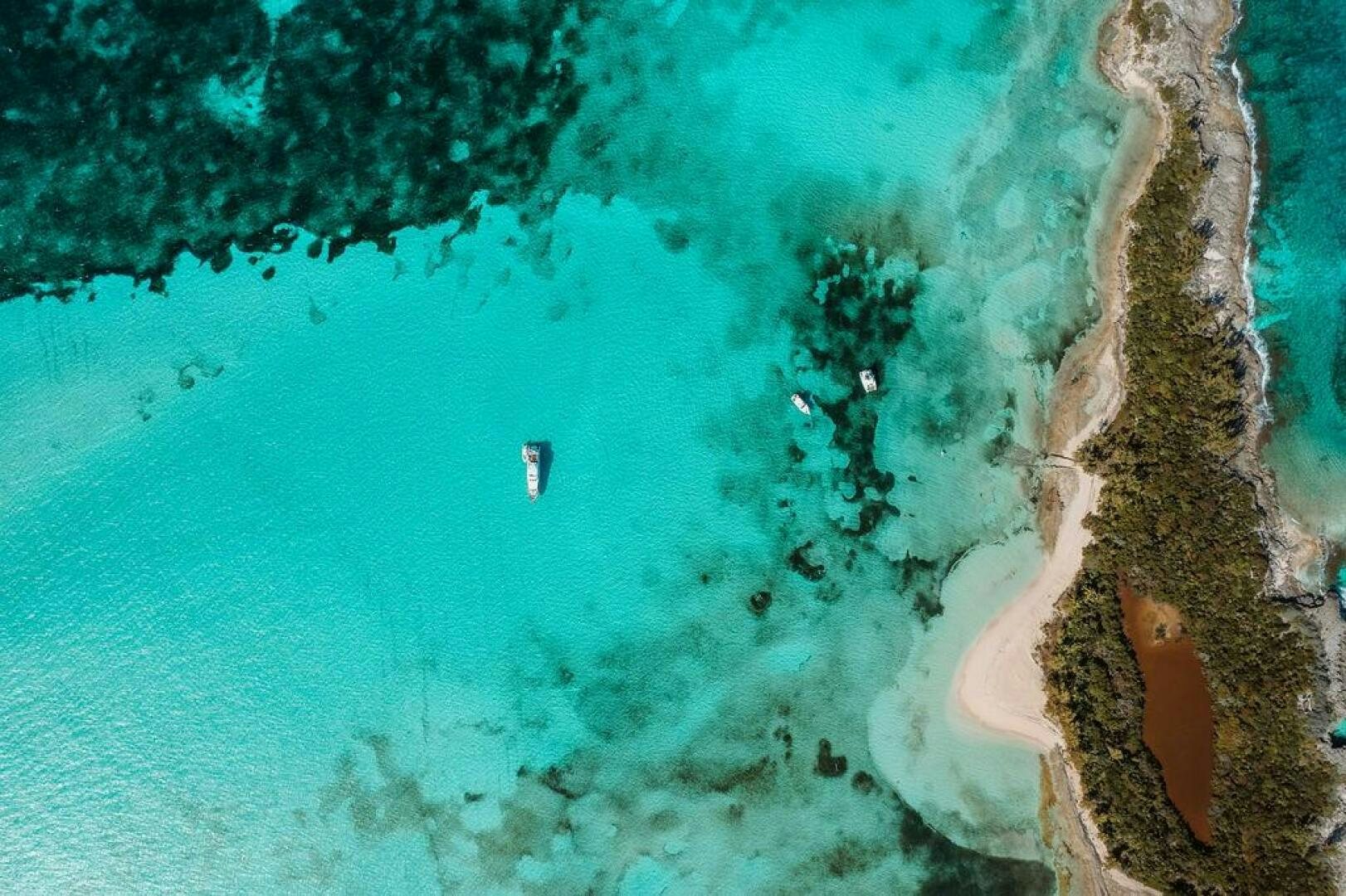a person swimming in a body of water aboard BEACHFRONT Yacht for Sale