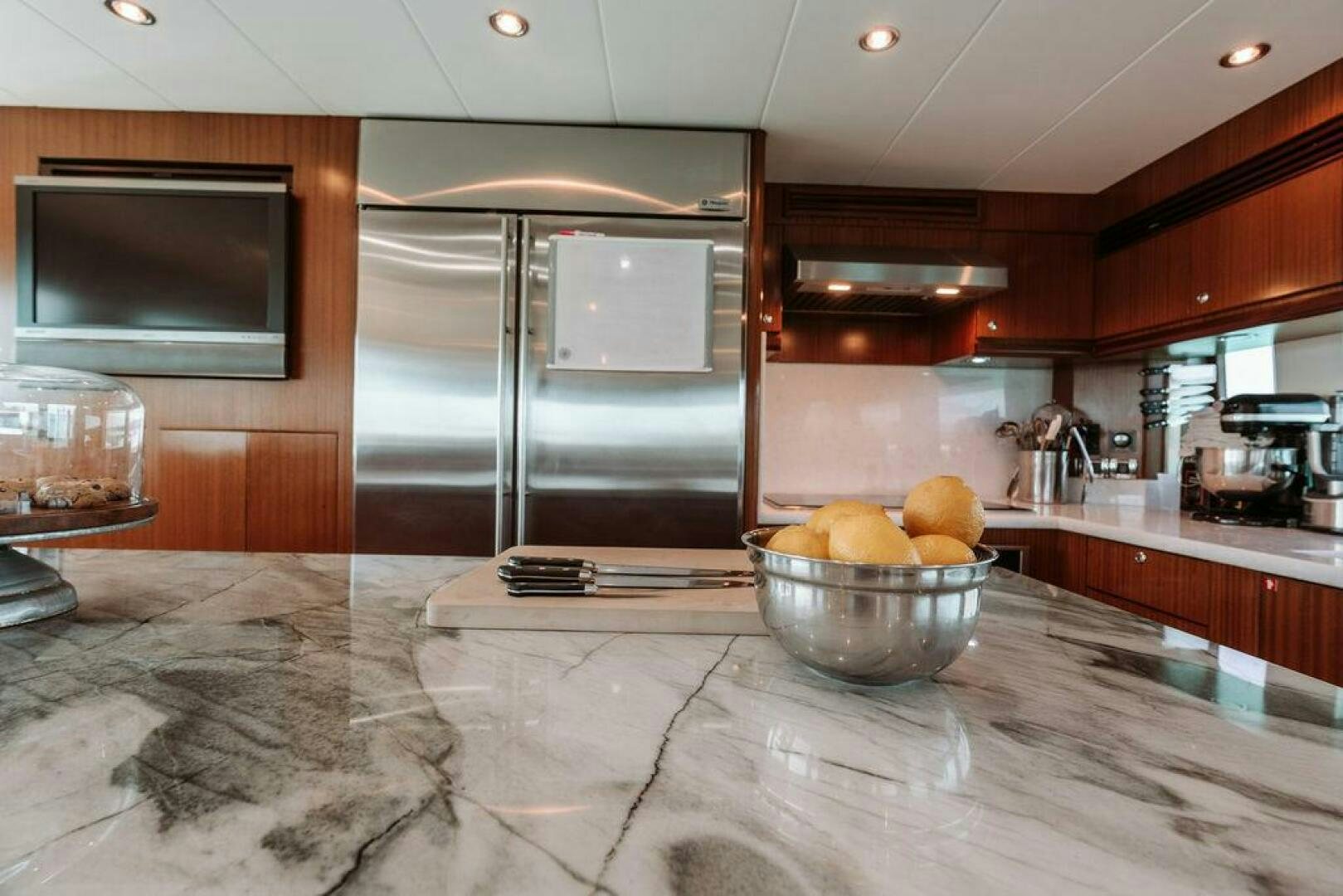 a kitchen with a stainless steel refrigerator aboard BEACHFRONT Yacht for Sale
