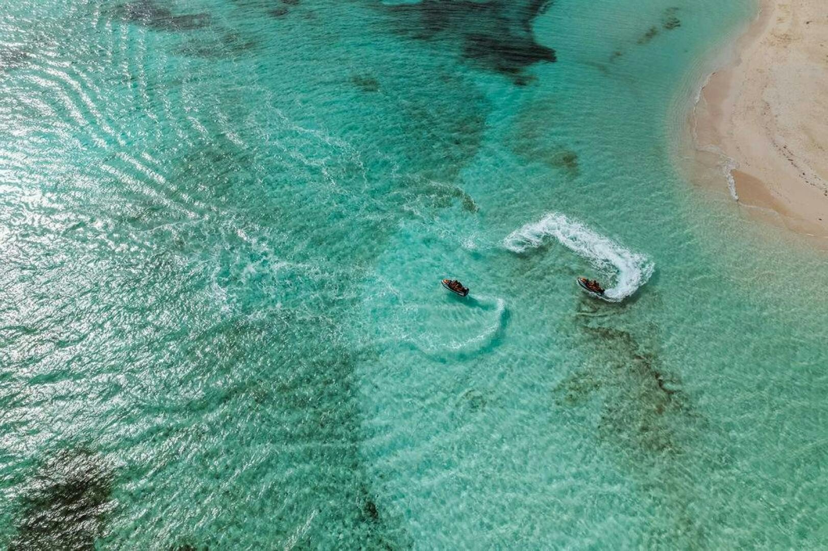 a group of people swimming in the water aboard BEACHFRONT Yacht for Sale