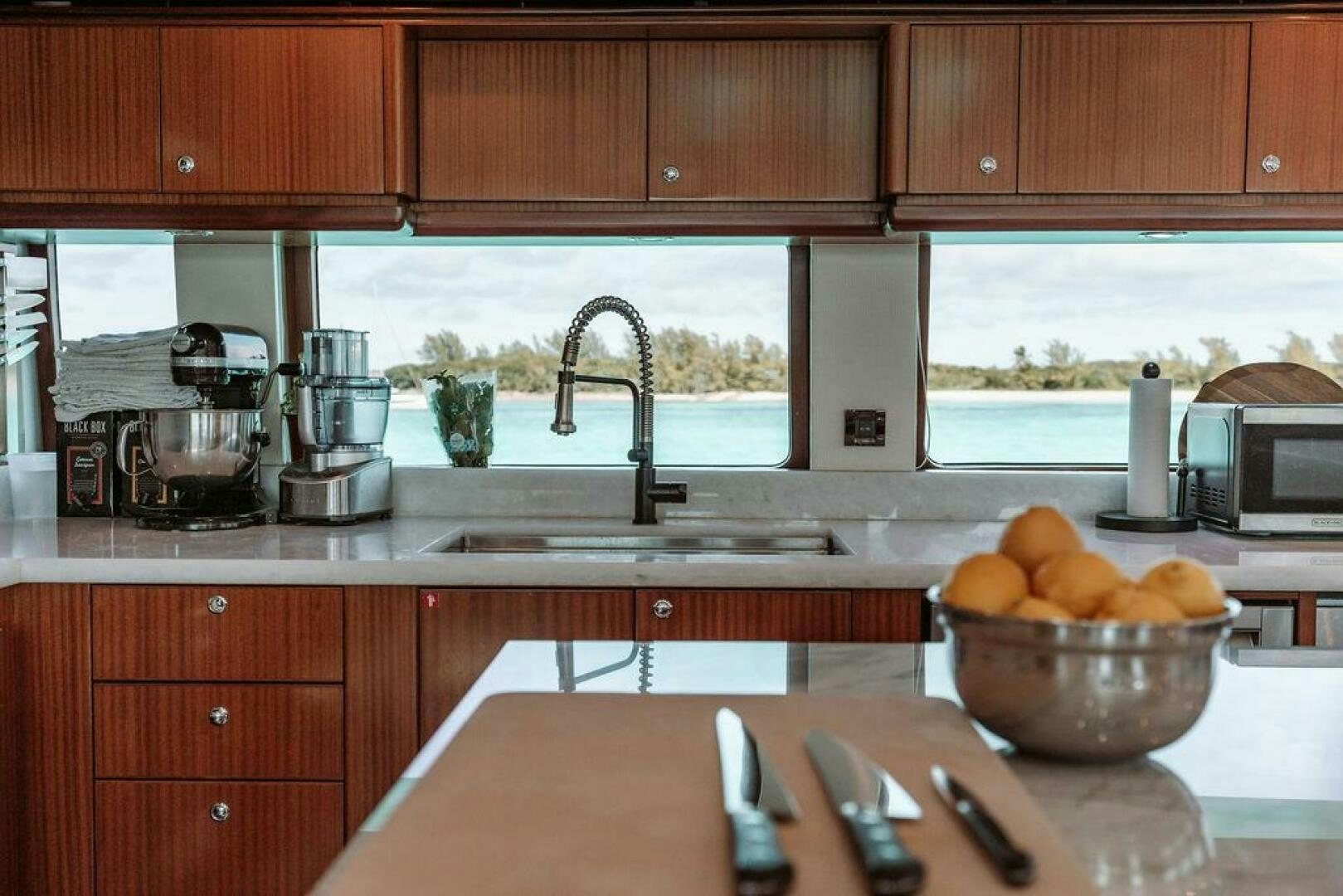 a kitchen with wooden cabinets aboard BEACHFRONT Yacht for Sale