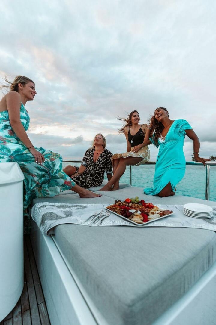 a group of women sitting on a boat on the water aboard BEACHFRONT Yacht for Sale