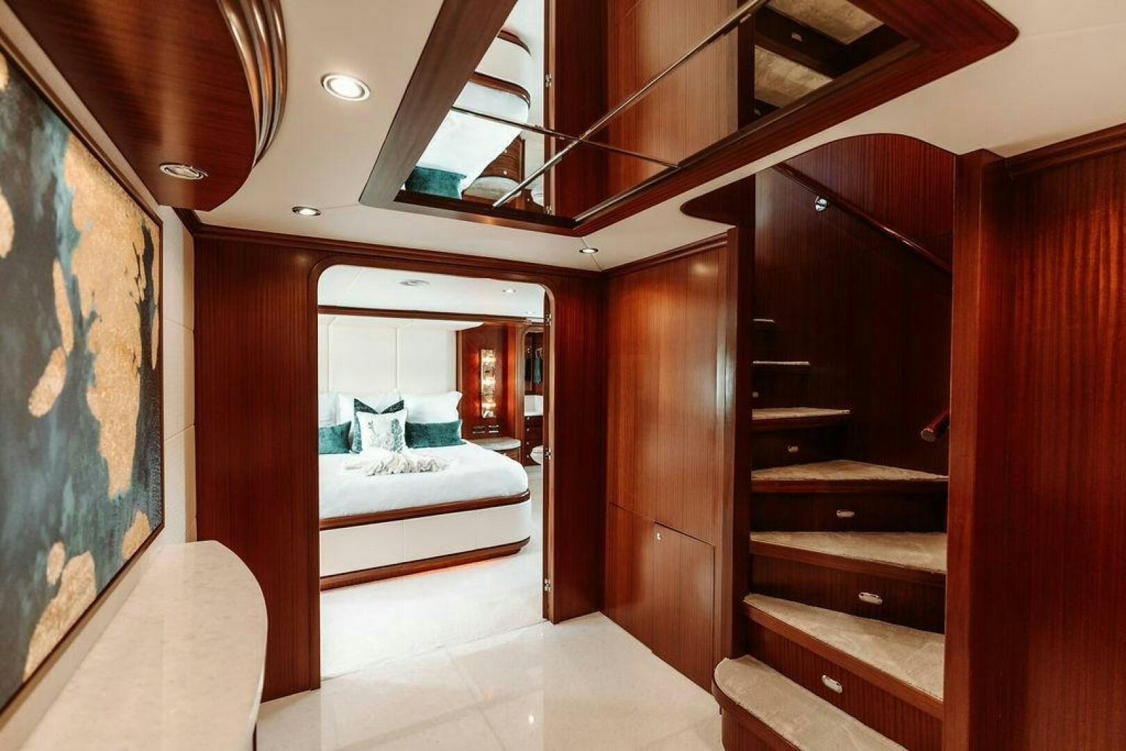 a room with a bed and a mirror aboard BEACHFRONT Yacht for Sale