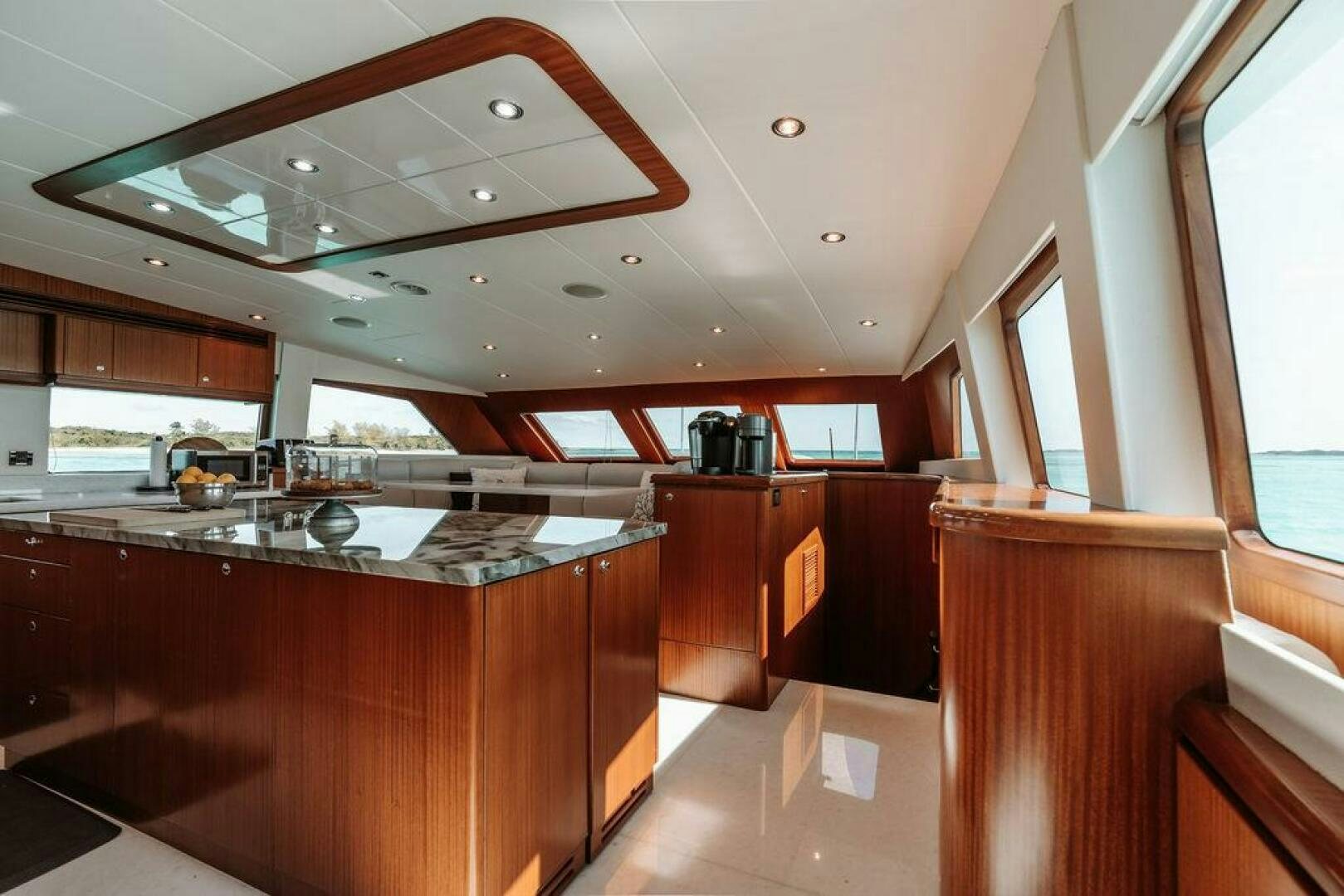 a kitchen with wooden cabinets aboard BEACHFRONT Yacht for Sale