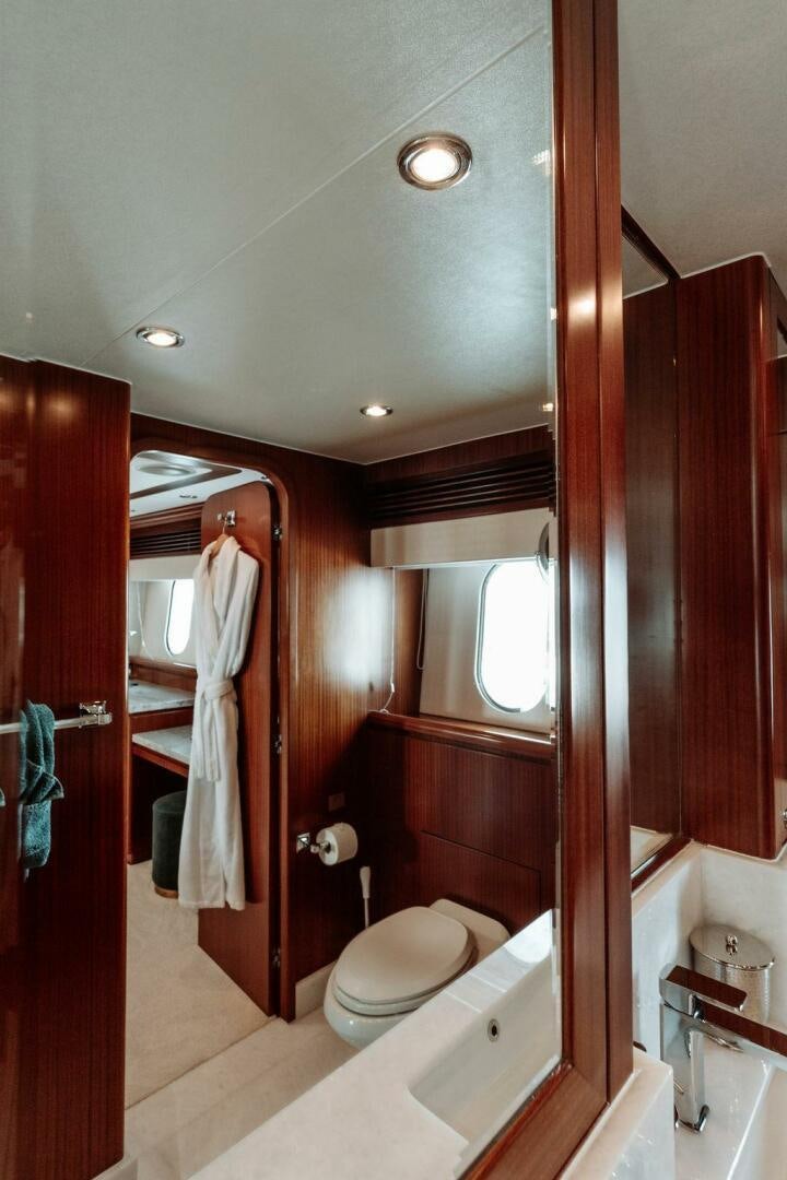 a bathroom with a tub sink and toilet aboard BEACHFRONT Yacht for Sale