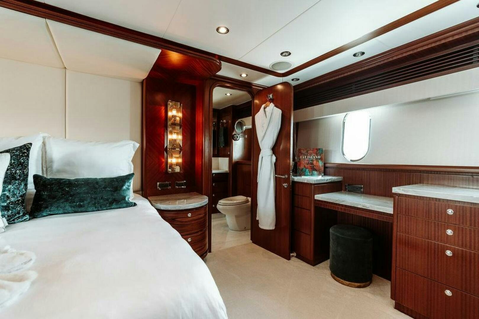 a bedroom with a bed and a sink aboard BEACHFRONT Yacht for Sale