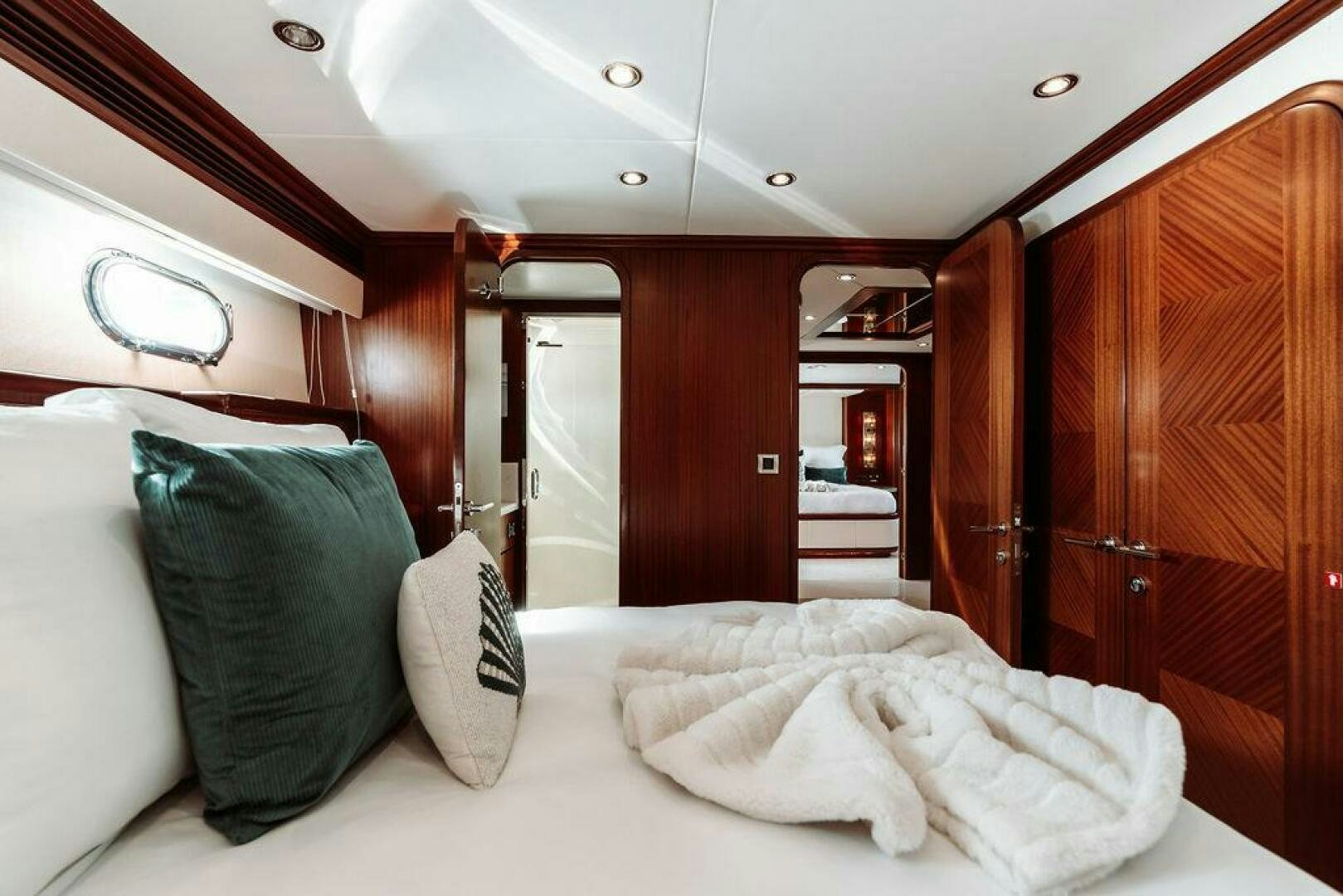 a bed with pillows on it aboard BEACHFRONT Yacht for Sale