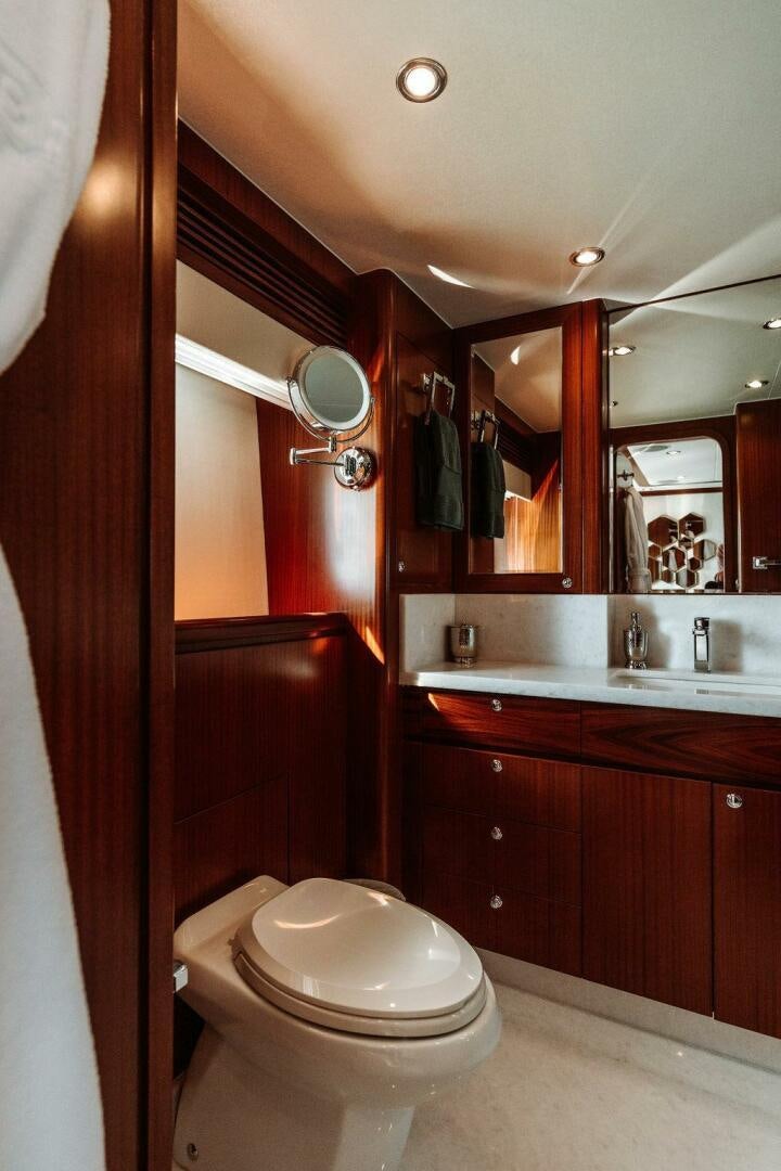 a bathroom with a toilet and a sink aboard BEACHFRONT Yacht for Sale
