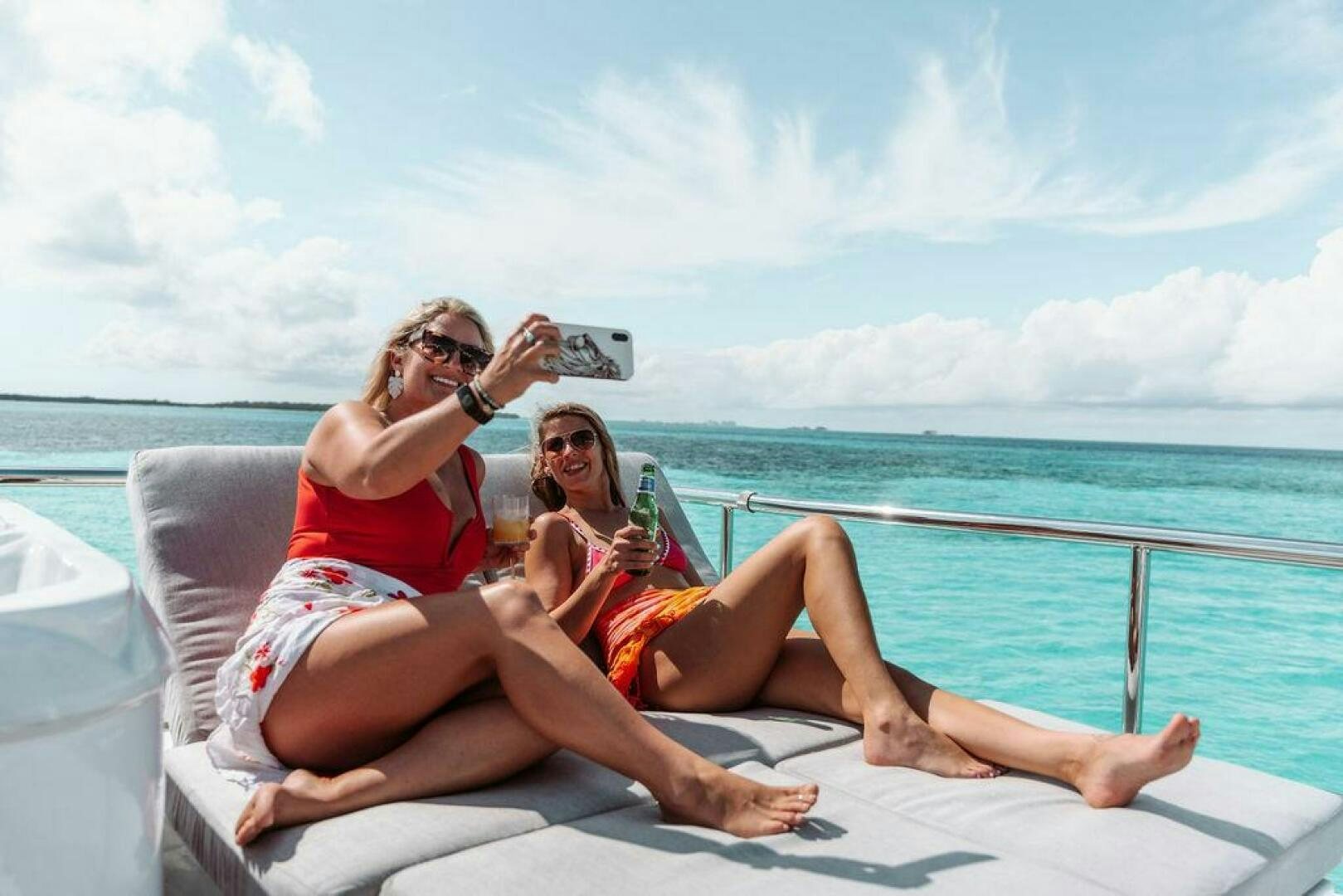 a group of women sitting on a beach aboard BEACHFRONT Yacht for Sale