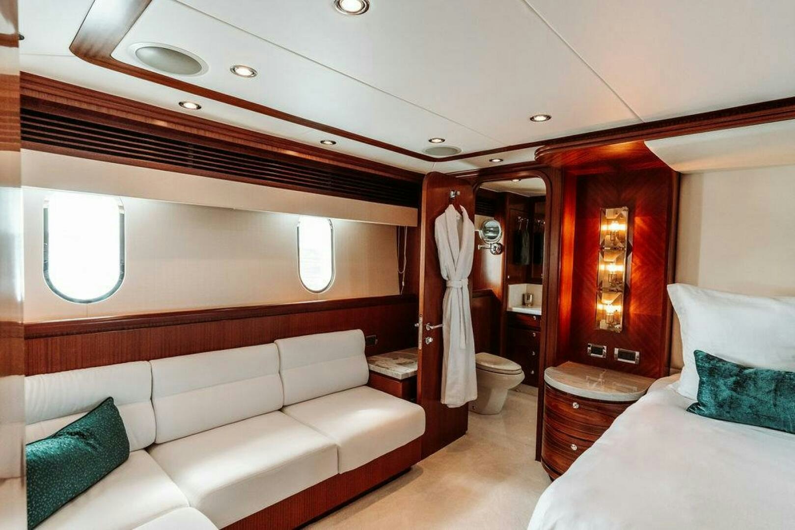 a room with a bed and a couch aboard BEACHFRONT Yacht for Sale