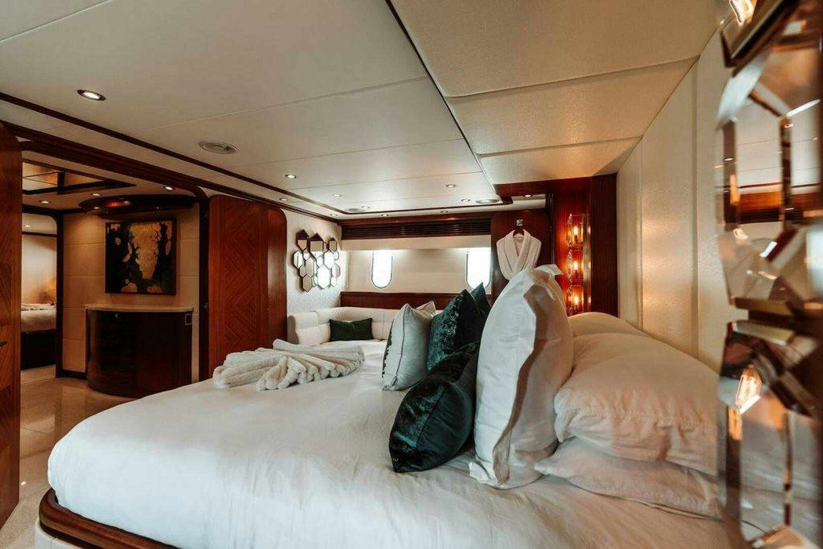 a large bed with white sheets aboard BEACHFRONT Yacht for Sale