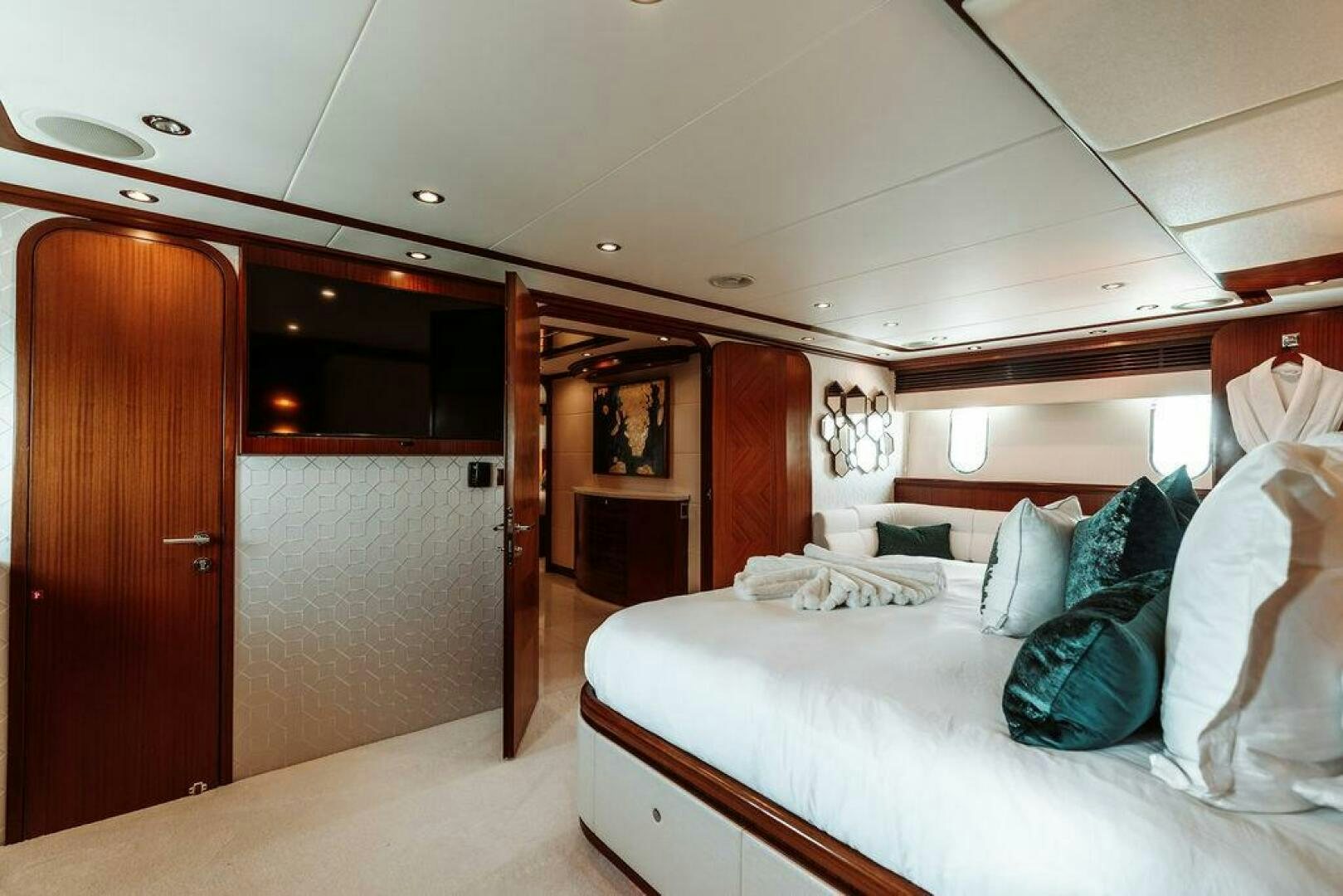 a bedroom with a bed and a closet aboard BEACHFRONT Yacht for Sale