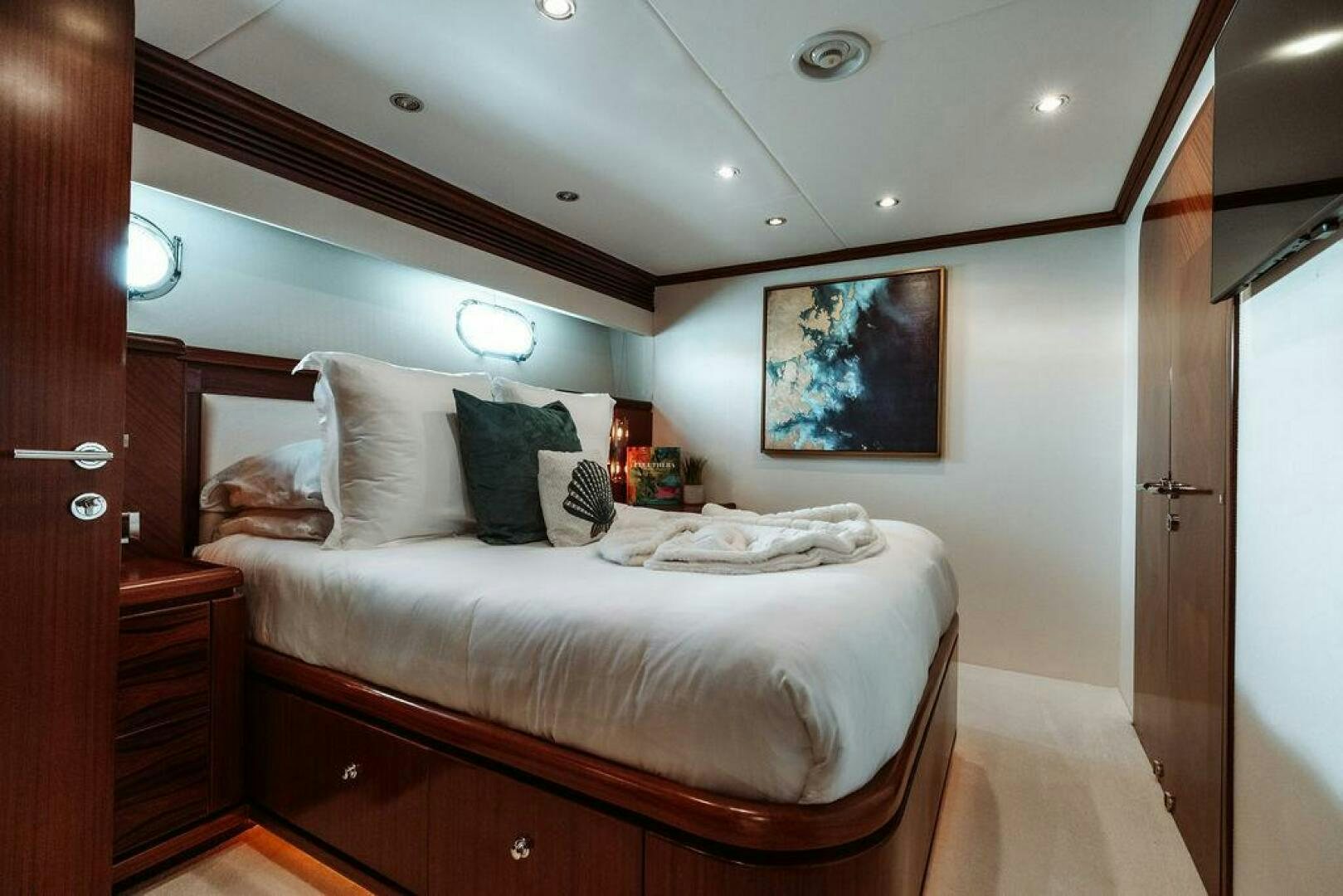 a bed with a white sheet and pillows on it aboard BEACHFRONT Yacht for Sale