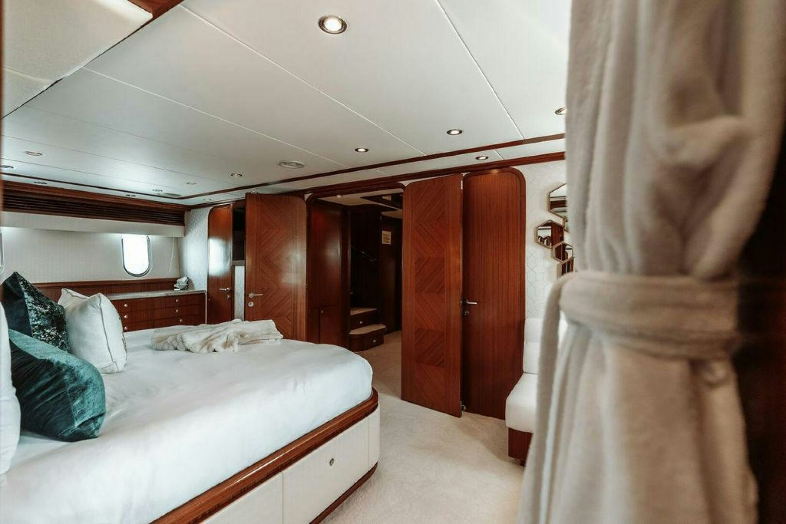 a room with a bed and a closet aboard BEACHFRONT Yacht for Sale