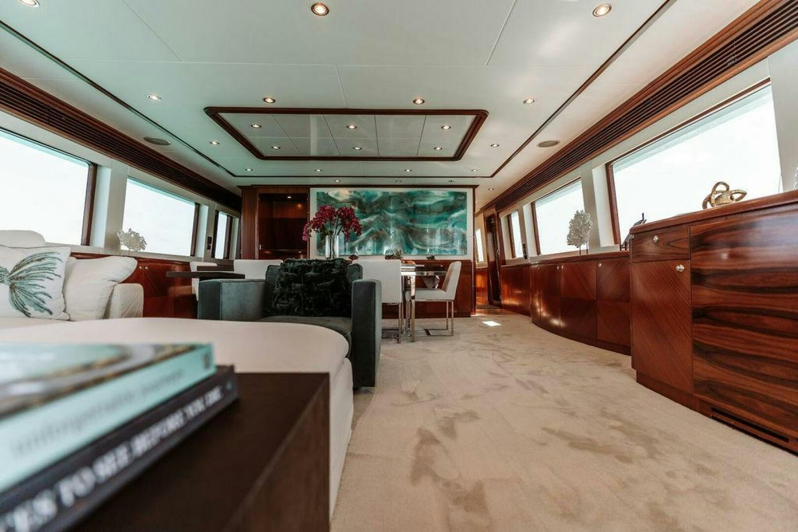 a large room with couches and a television aboard BEACHFRONT Yacht for Sale