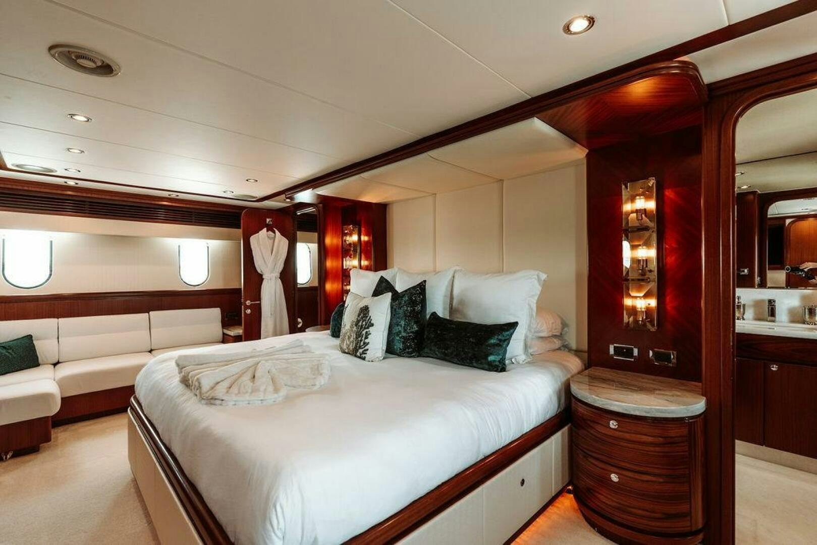 a room with a bed and a mirror aboard BEACHFRONT Yacht for Sale