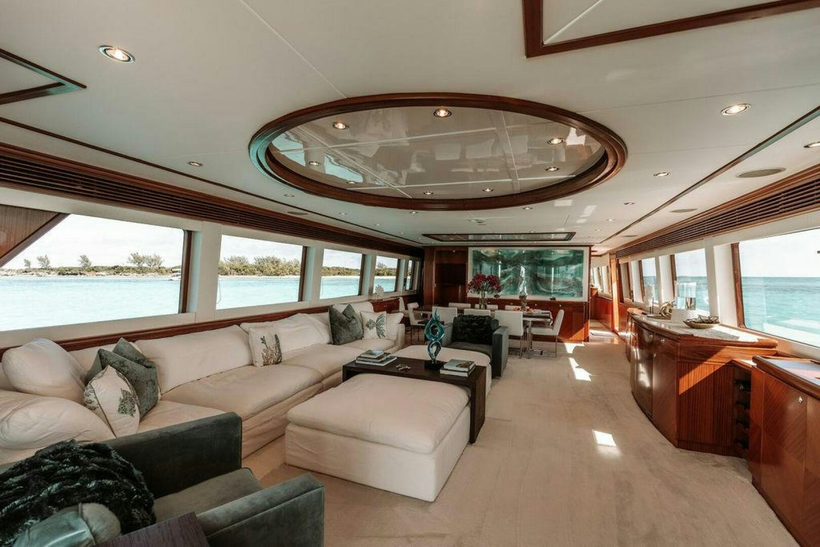 a living room with a large chandelier aboard BEACHFRONT Yacht for Sale