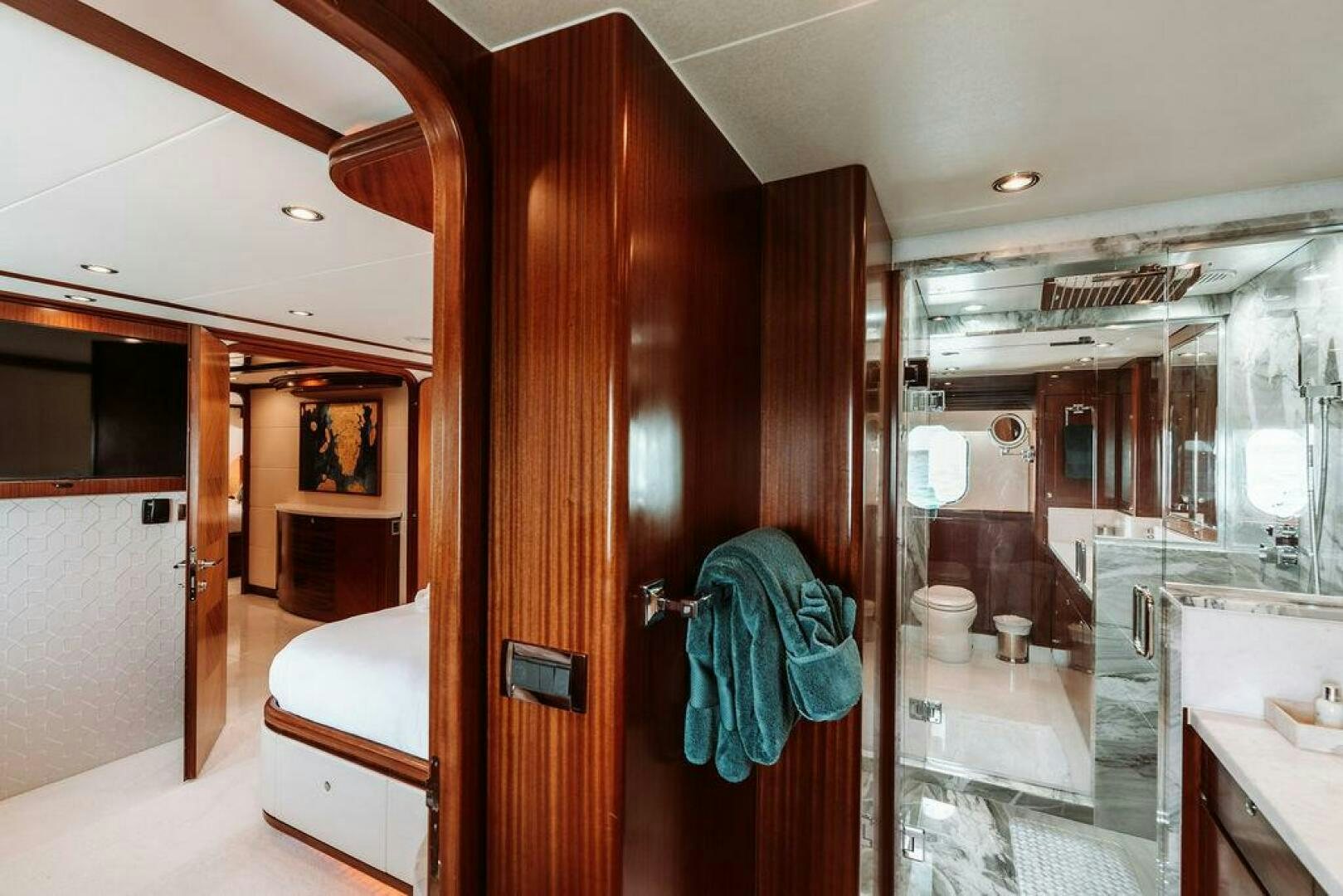a bathroom with a wood door aboard BEACHFRONT Yacht for Sale
