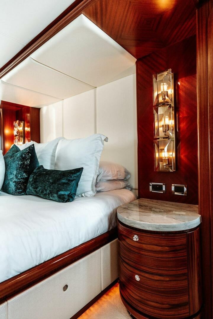 a bed with a mirror above it aboard BEACHFRONT Yacht for Sale