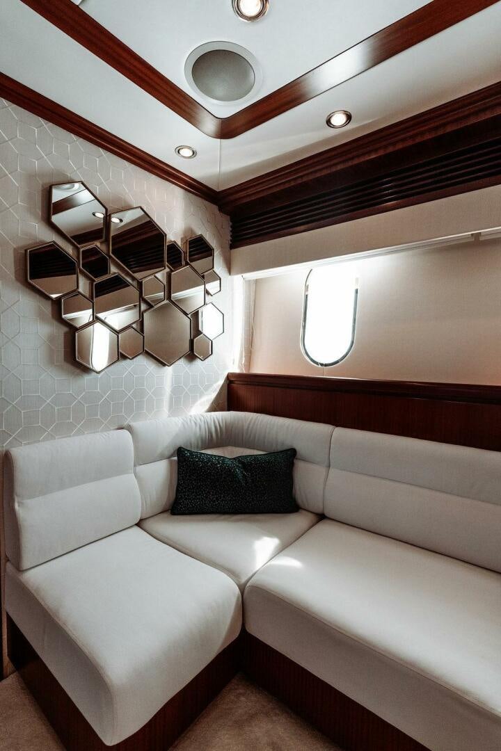a room with a couch and a mirror aboard BEACHFRONT Yacht for Sale