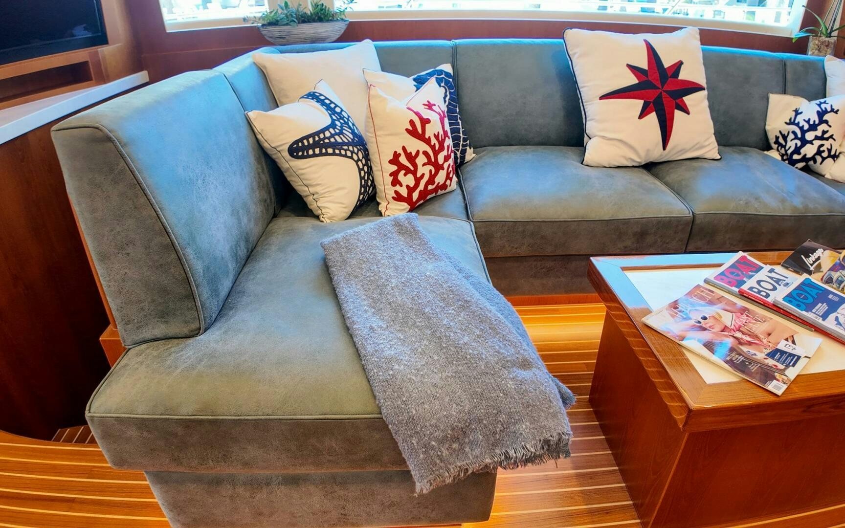 a couch with pillows and pillows aboard CASTINA Yacht for Sale
