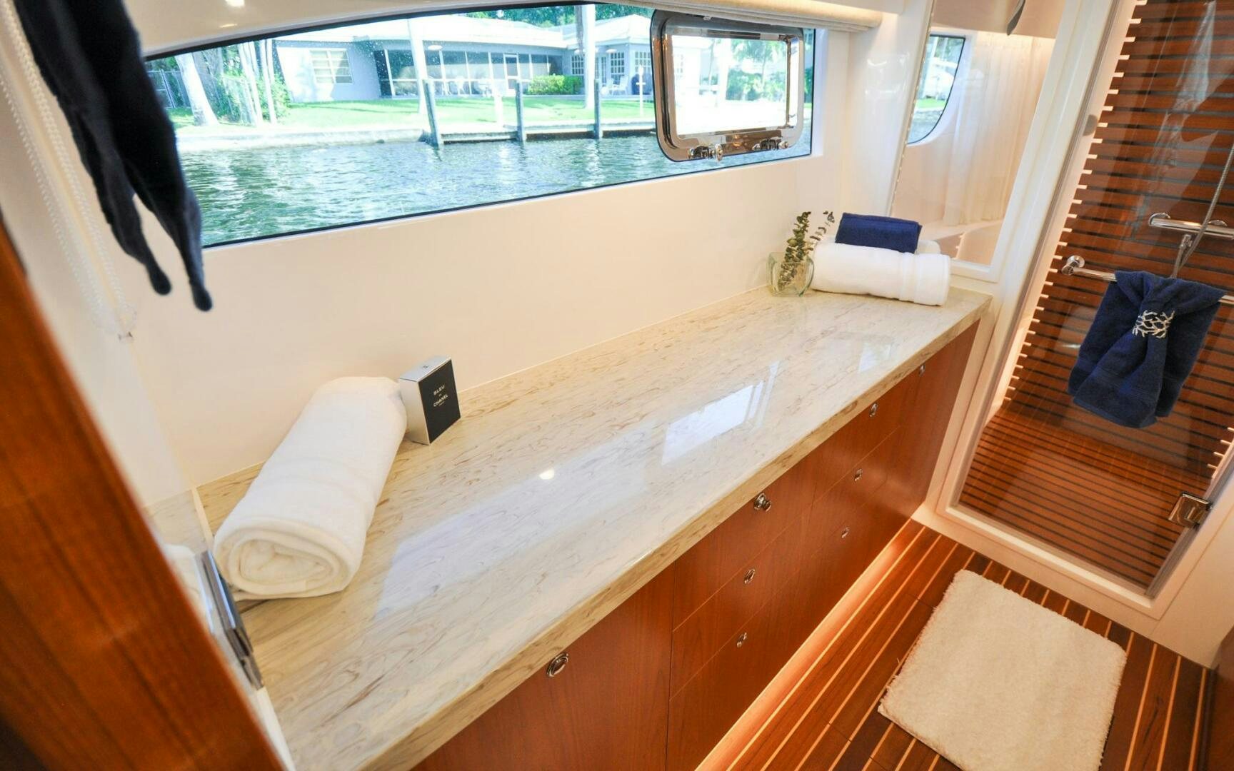 a room with a large window and a table with chairs and a window aboard CASTINA Yacht for Sale