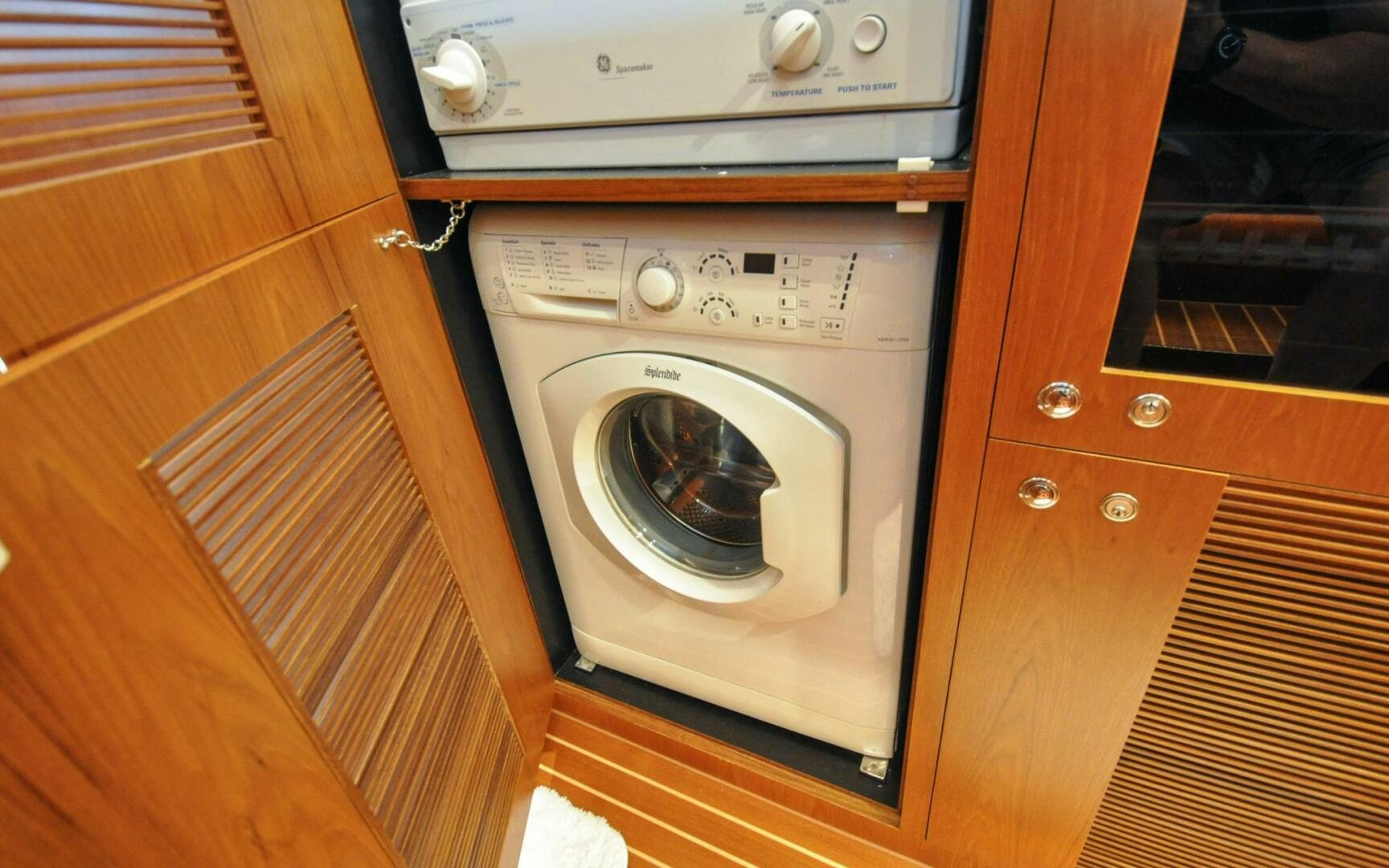 a washing machine in a kitchen aboard CASTINA Yacht for Sale