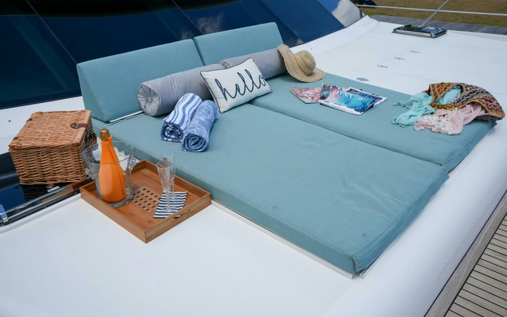 a bed with a blue sheet and pillows and a blue blanket aboard CASTINA Yacht for Sale