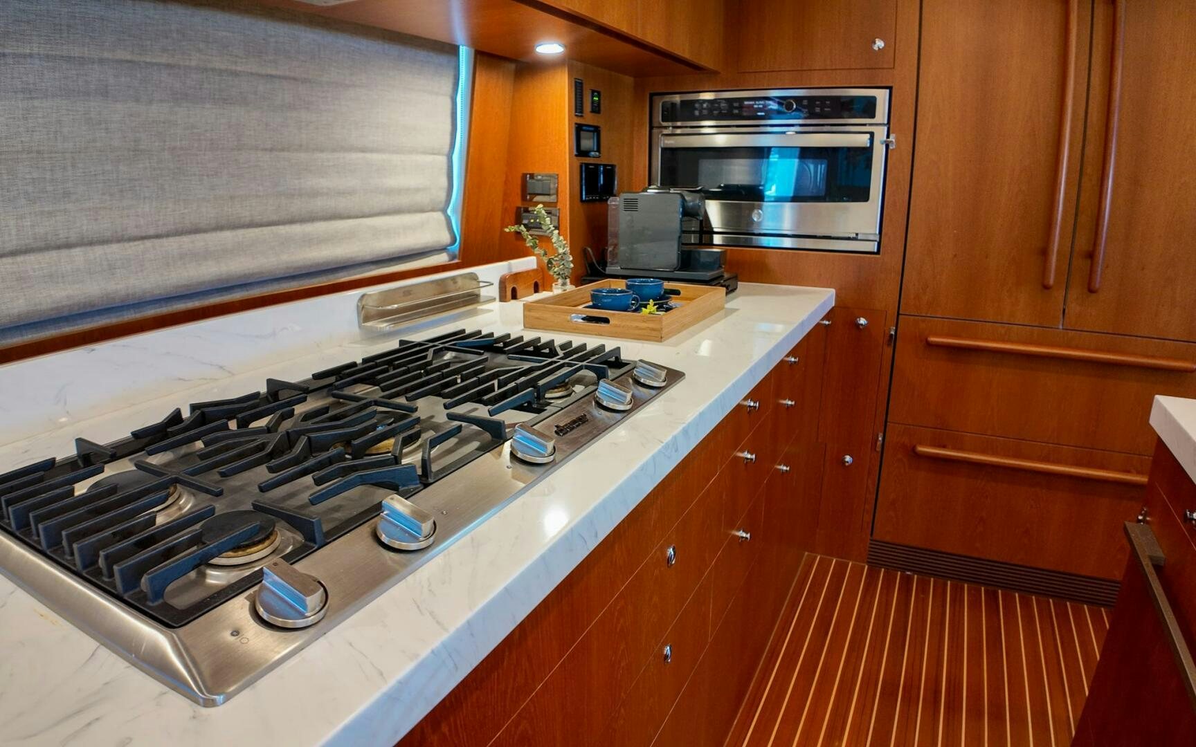a kitchen with wooden cabinets aboard CASTINA Yacht for Sale