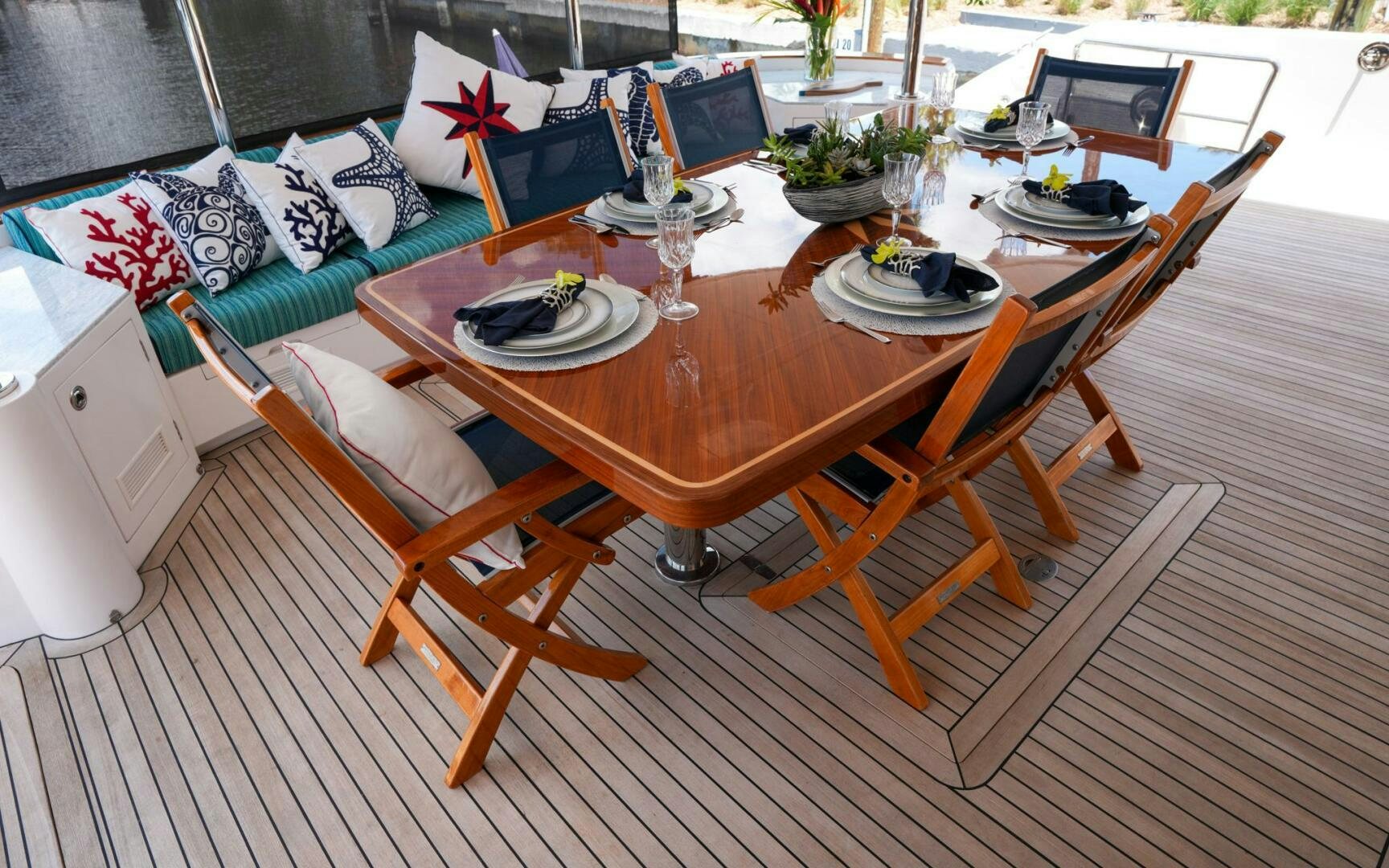 a table with plates and glasses on it aboard CASTINA Yacht for Sale
