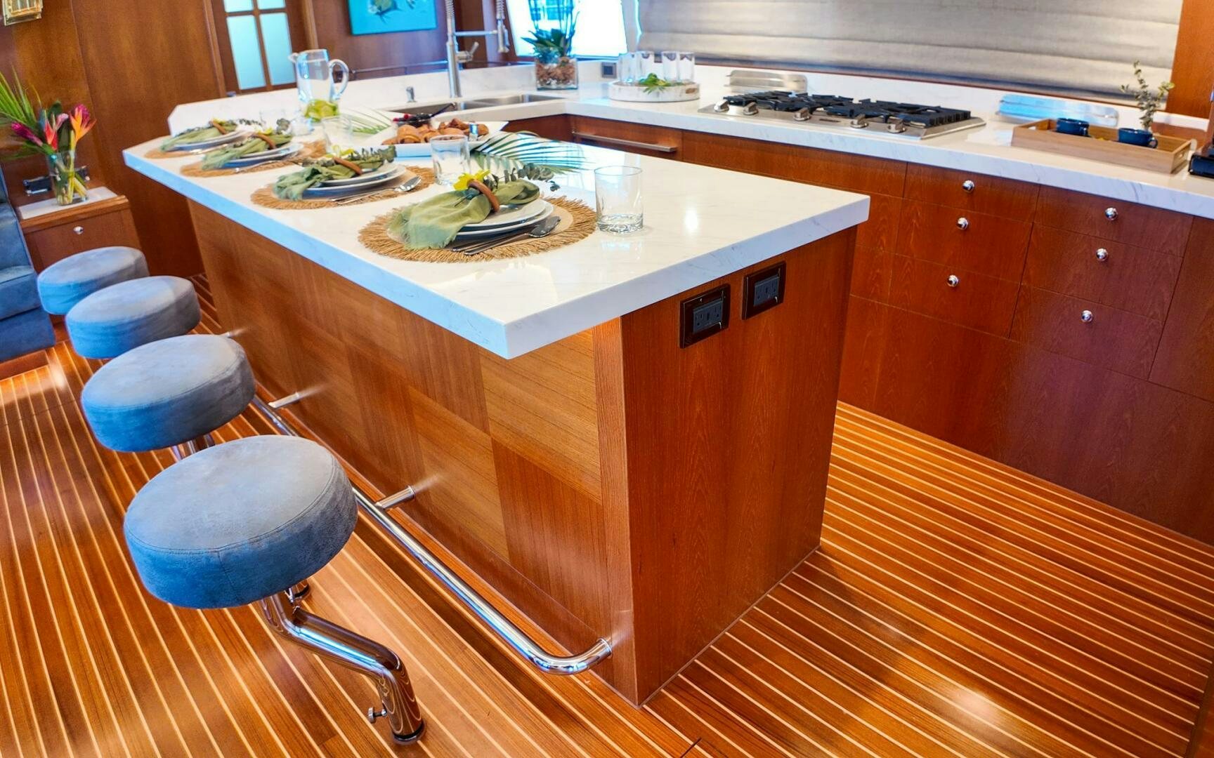 a kitchen counter with a table and chairs aboard CASTINA Yacht for Sale