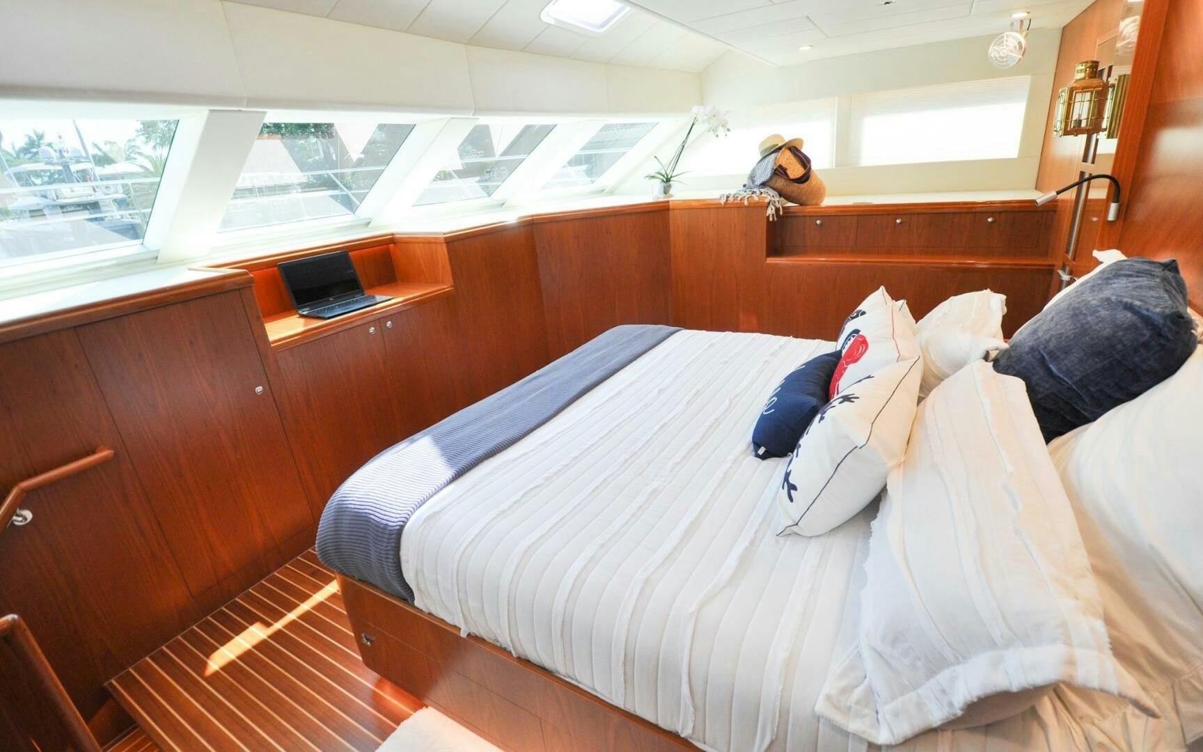 a bed with white sheets aboard CASTINA Yacht for Sale