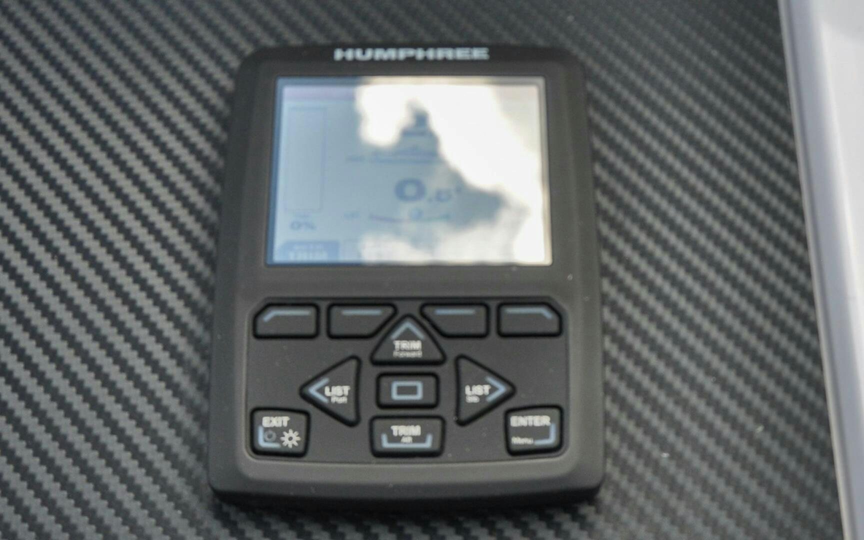 a cell phone on a book aboard CASTINA Yacht for Sale