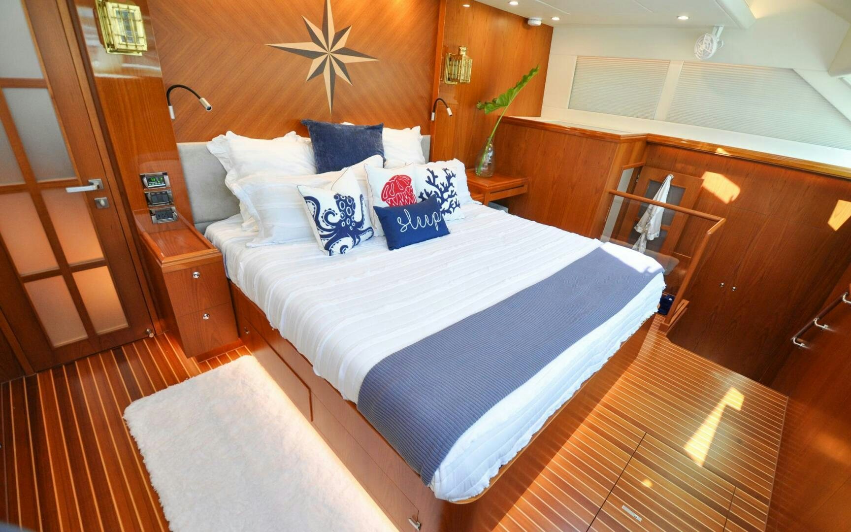 a bed with white sheets and pillows aboard CASTINA Yacht for Sale