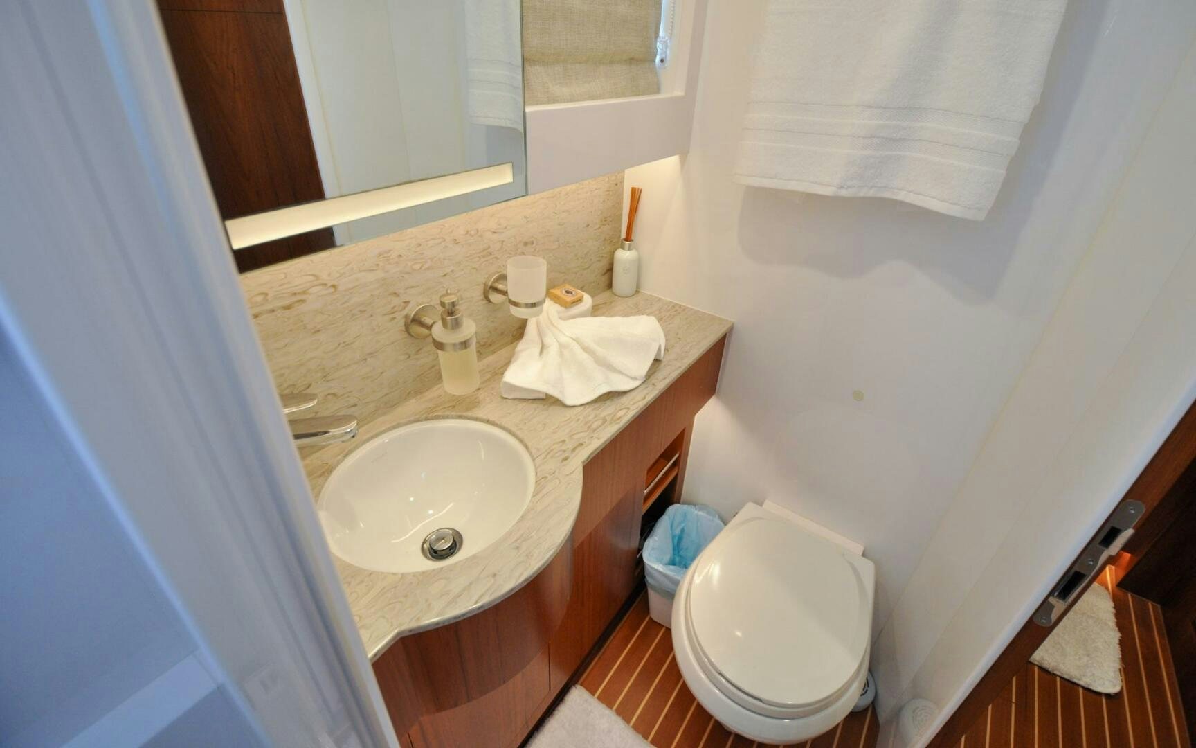 a bathroom with a sink and towels aboard CASTINA Yacht for Sale