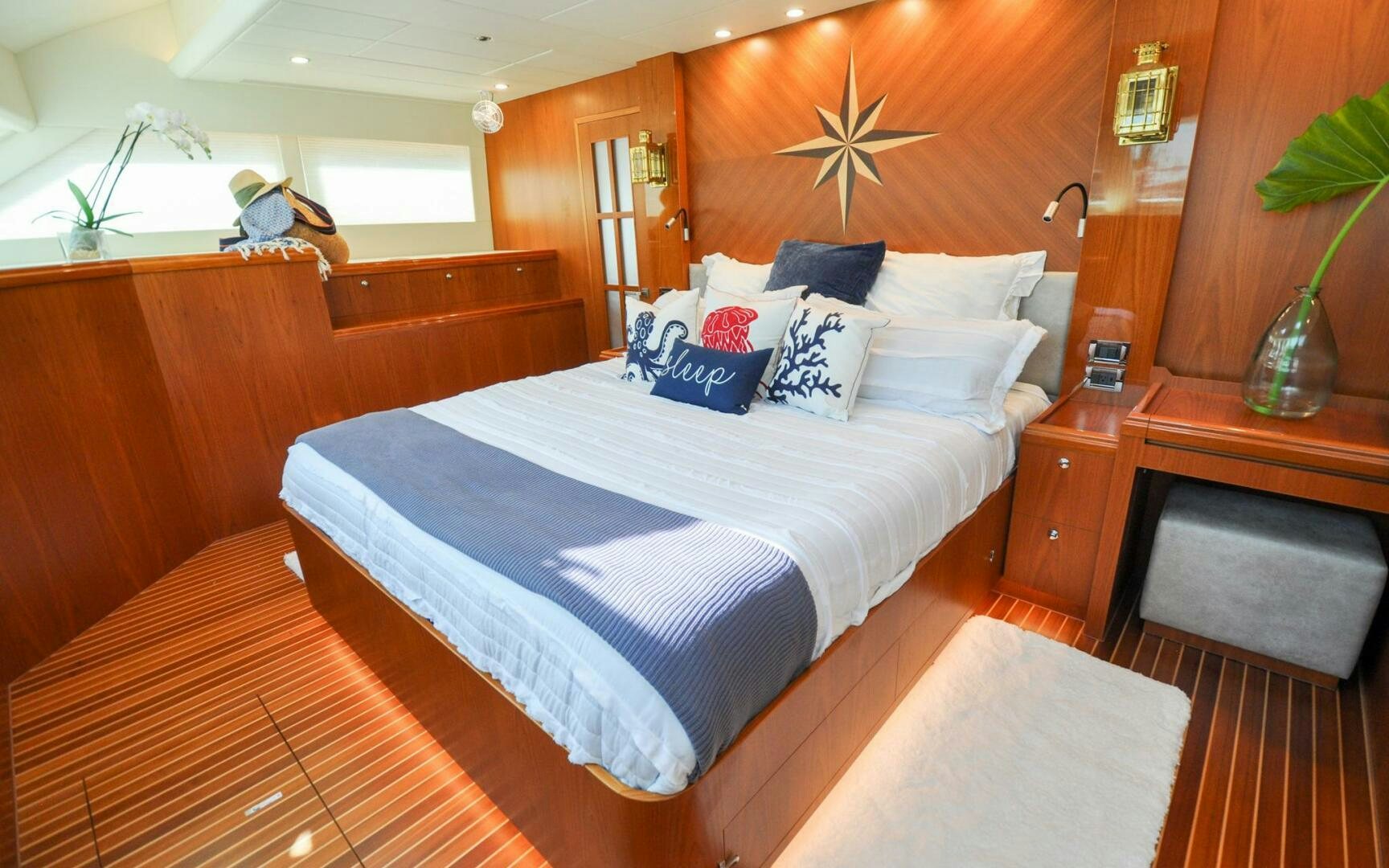 a bed with white sheets and pillows aboard CASTINA Yacht for Sale