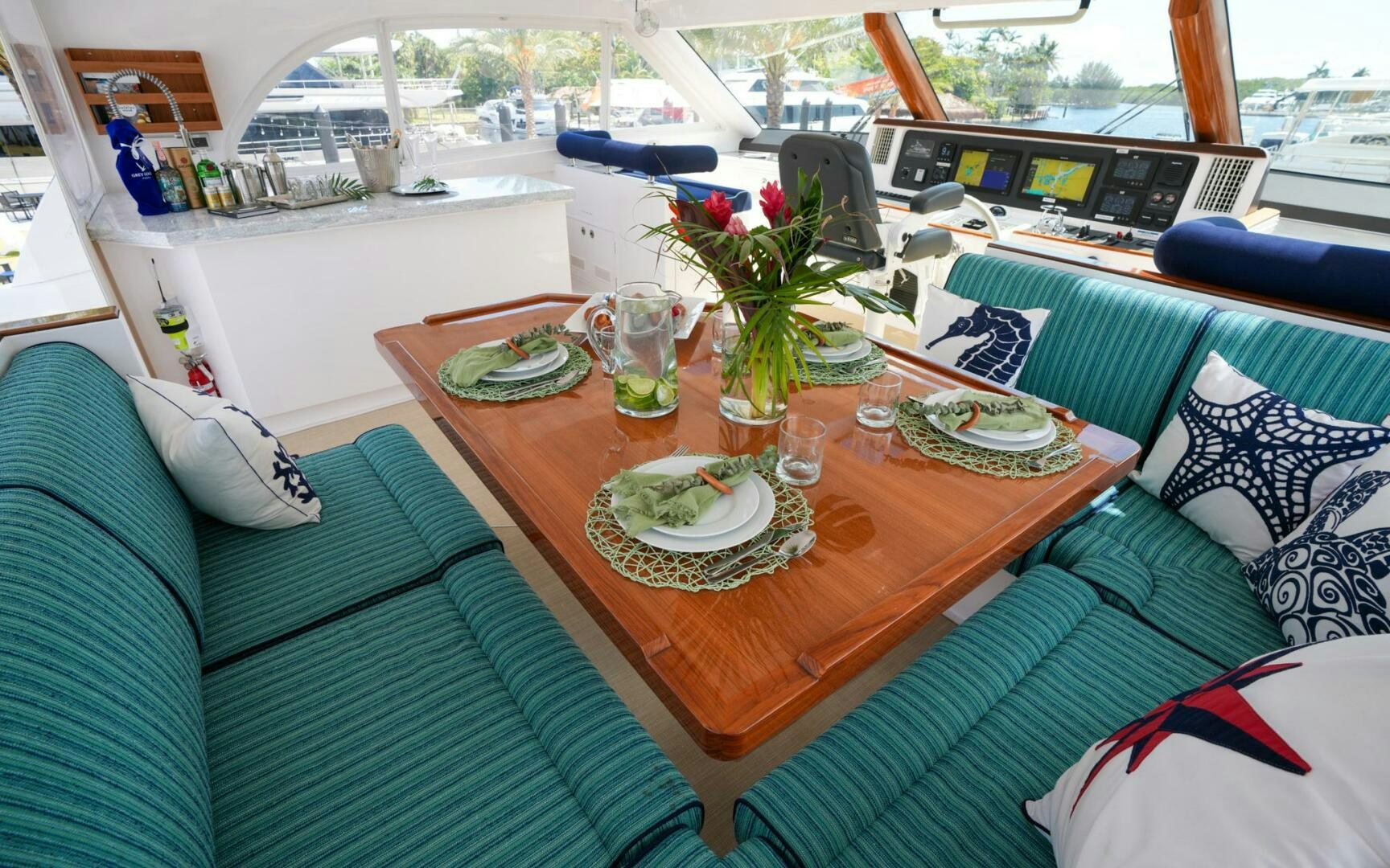 a table with plates and glasses on it aboard CASTINA Yacht for Sale