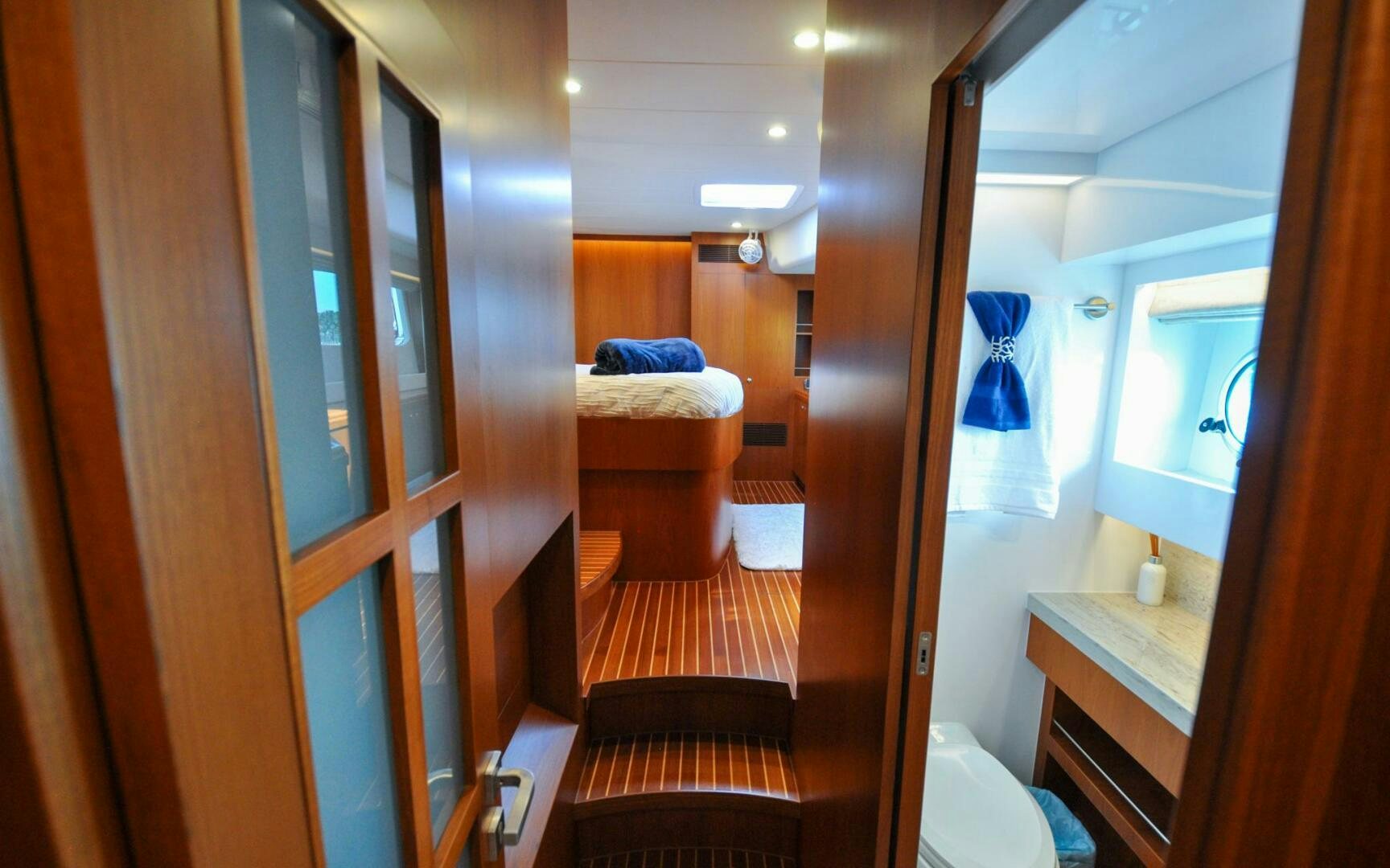 a bathroom with a wood door aboard CASTINA Yacht for Sale