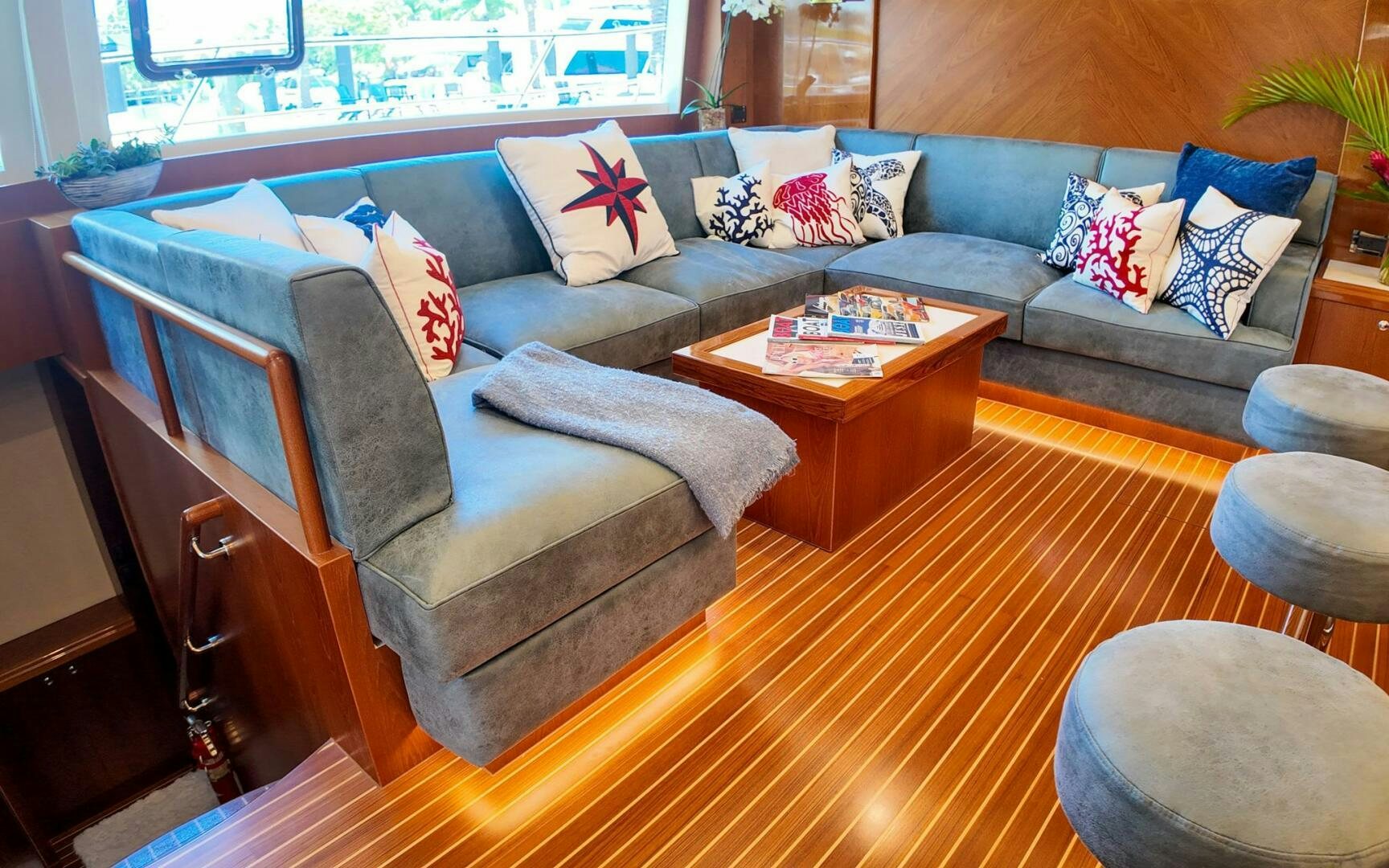 a living room with a couch and a coffee table aboard CASTINA Yacht for Sale