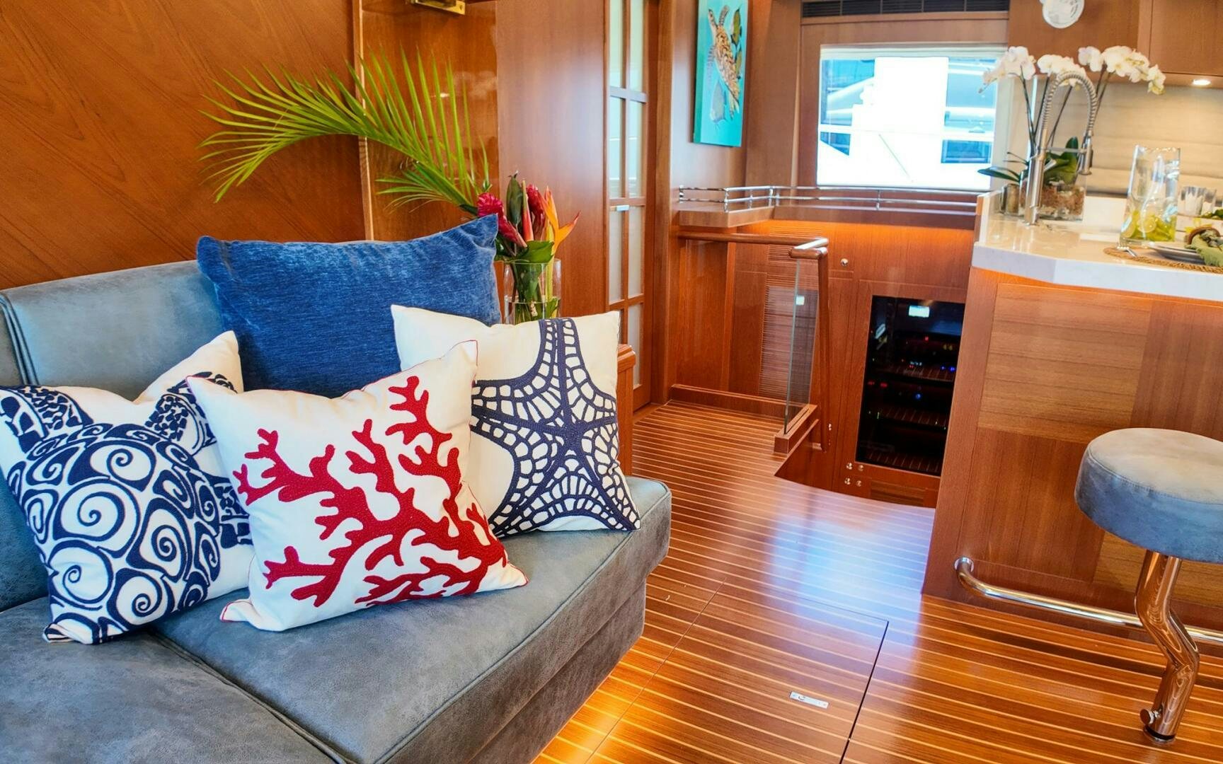 a living room with a couch and a table aboard CASTINA Yacht for Sale