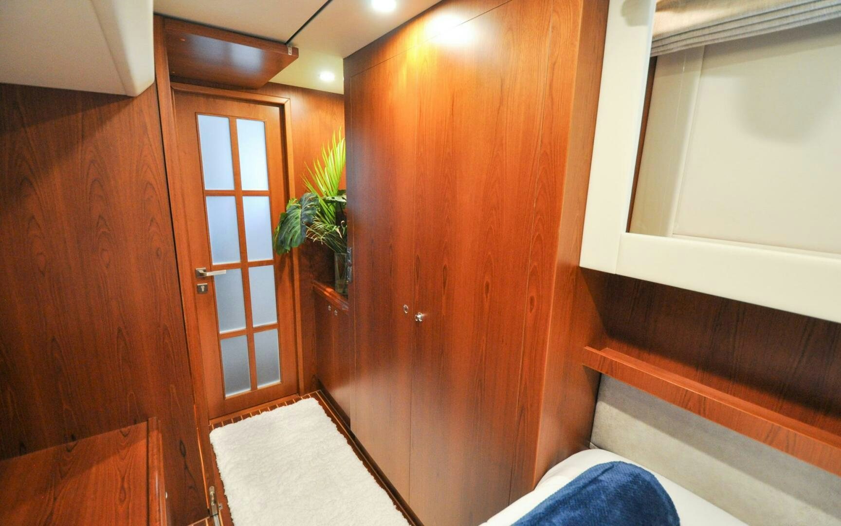 a room with wooden cabinets aboard CASTINA Yacht for Sale