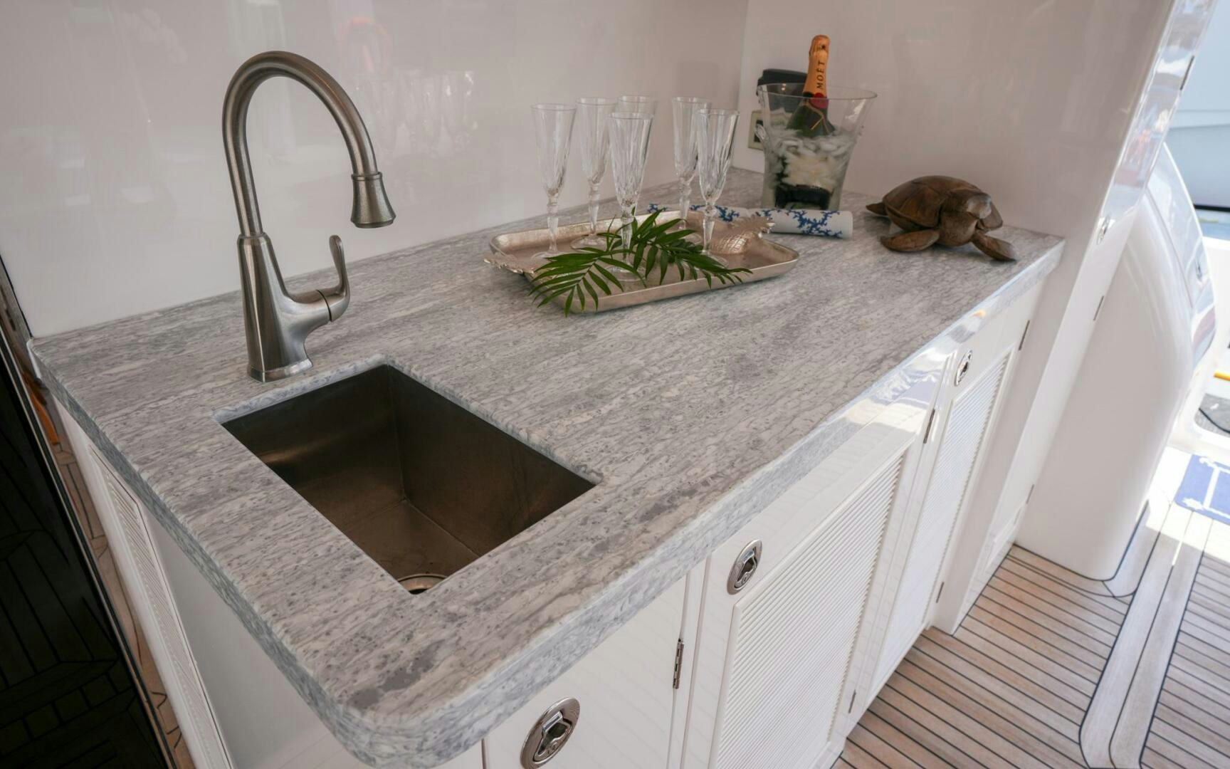 a kitchen counter with a sink and a plant on it aboard CASTINA Yacht for Sale